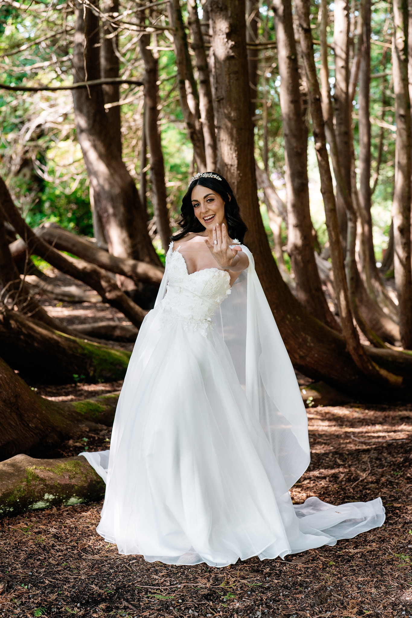 Bride showing her wedding ring during woodland portraits at Markree Castle