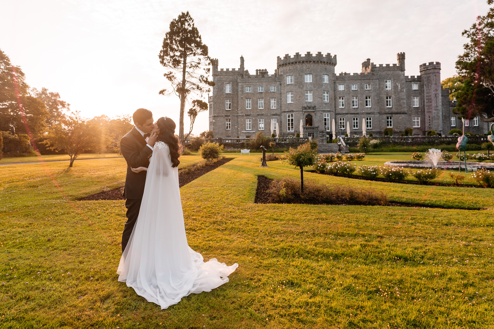 Bride and groom during golden hour wedding portraits in front of Markree Castle