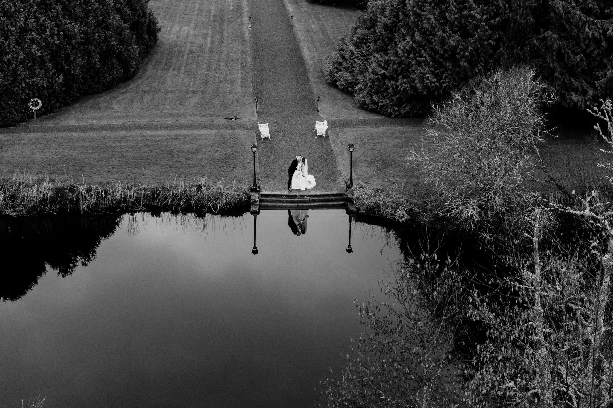 Aerial view of bride and groom beside the river at Markree Castle
