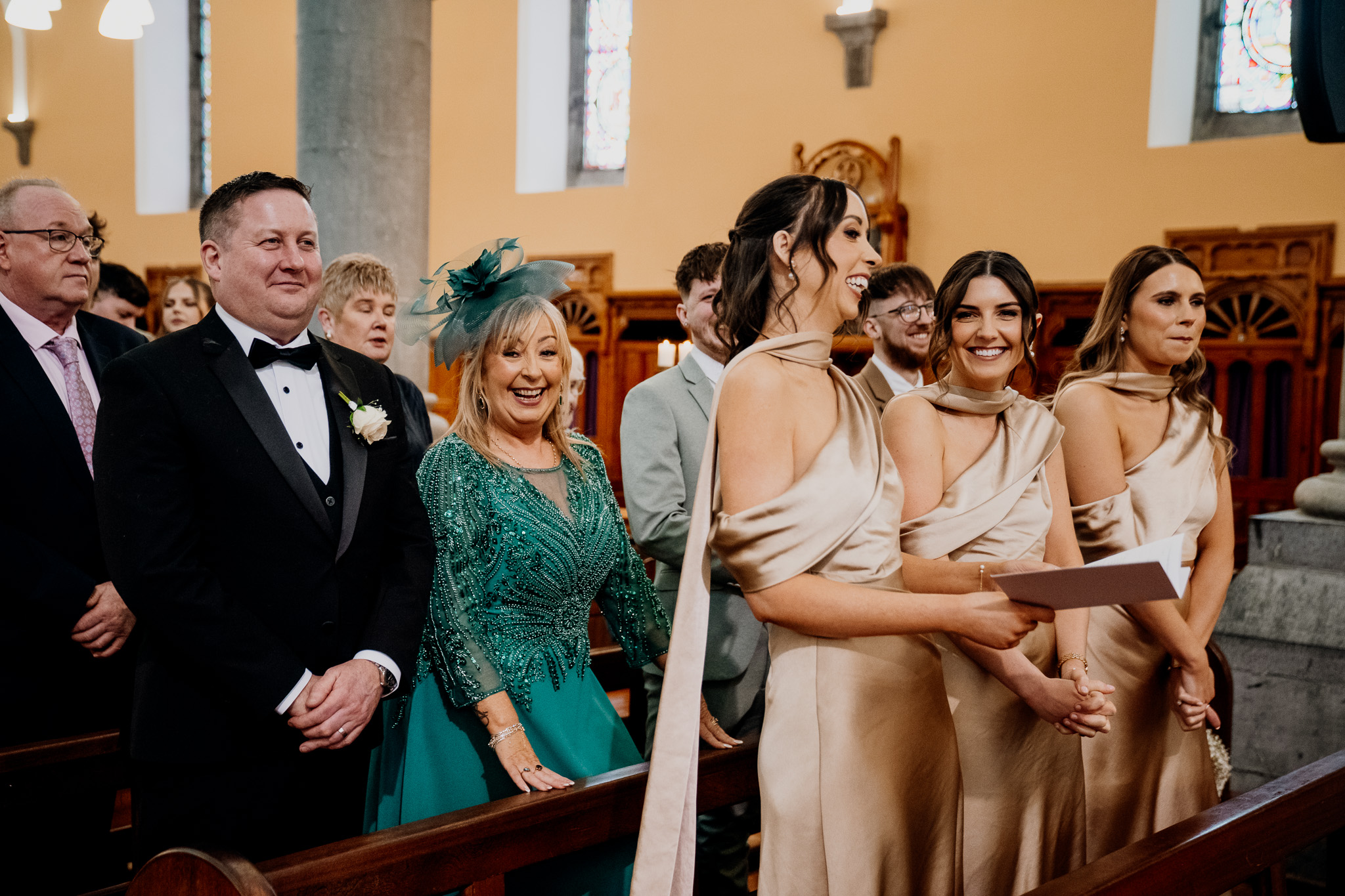 Wedding guests smiling during a ceremony at Sligo Cathedral