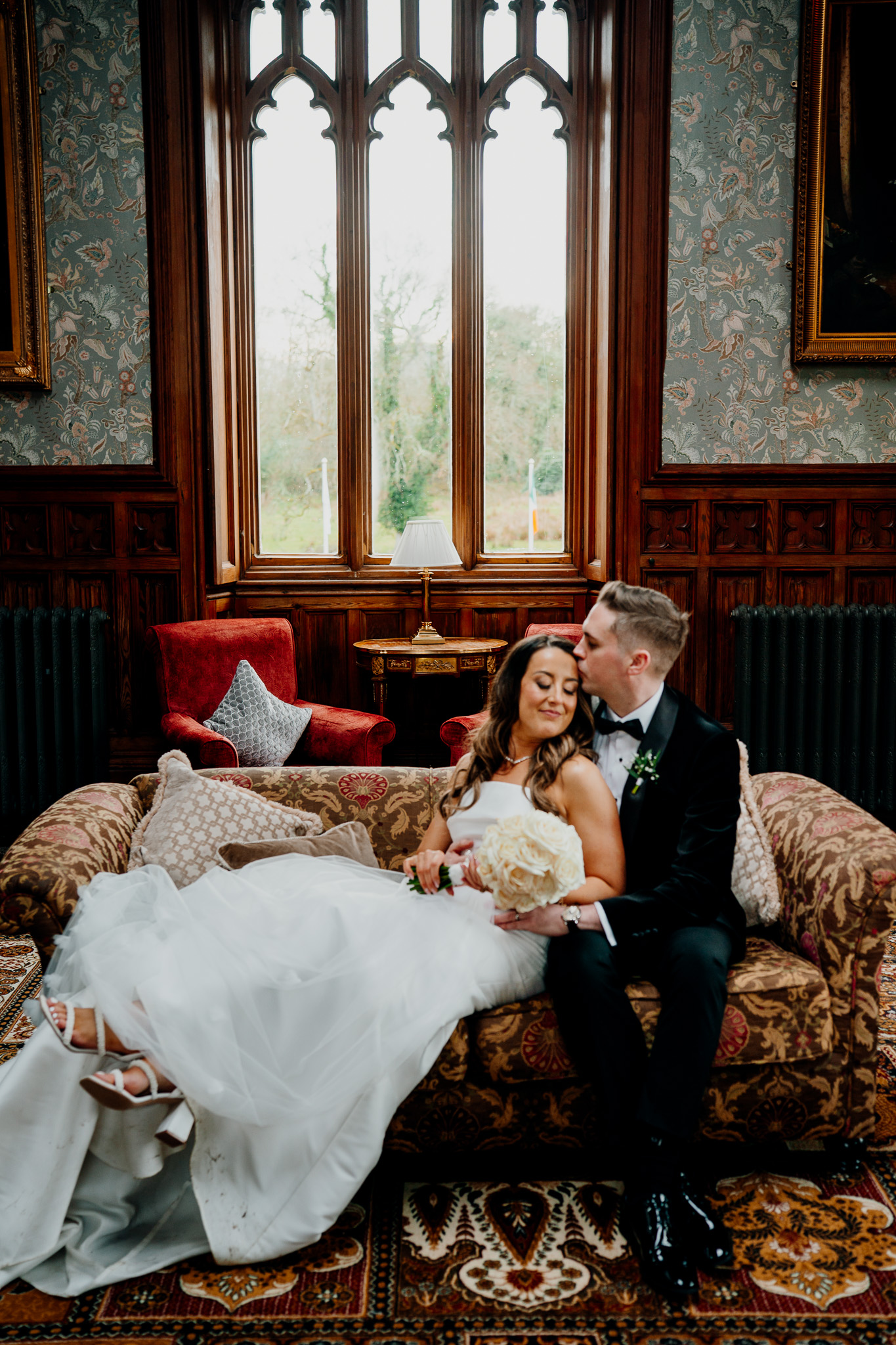 Bride and groom relaxing on the sofa in the Billiard Room at Markree Castle