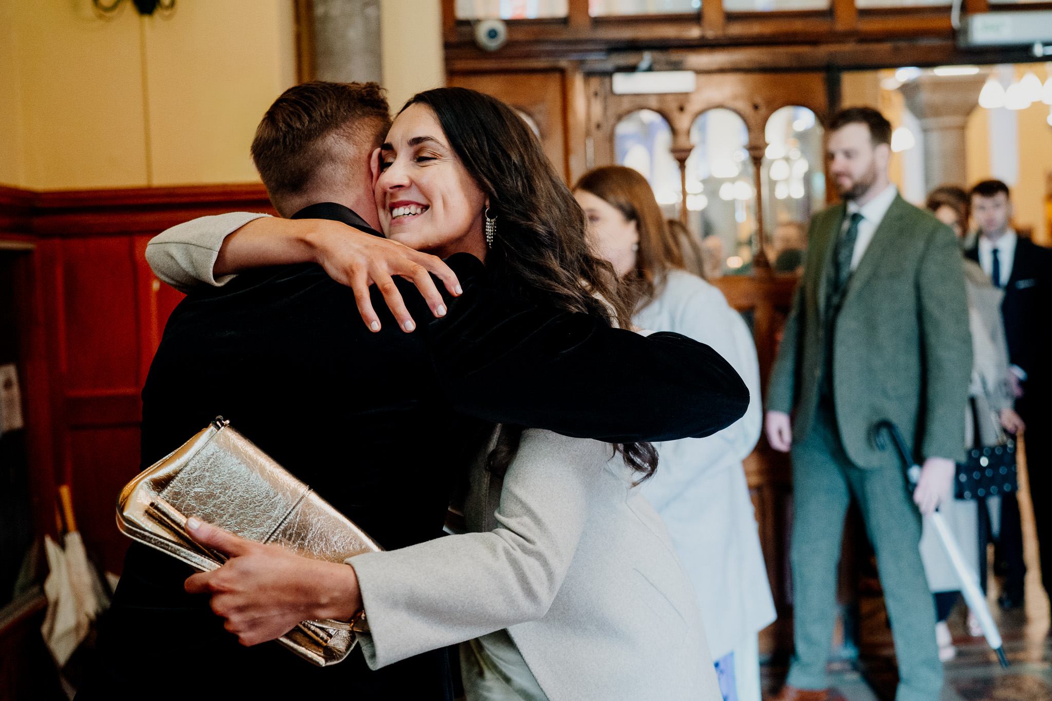 Wedding guest sharing a joyful hug after the ceremony in Sligo