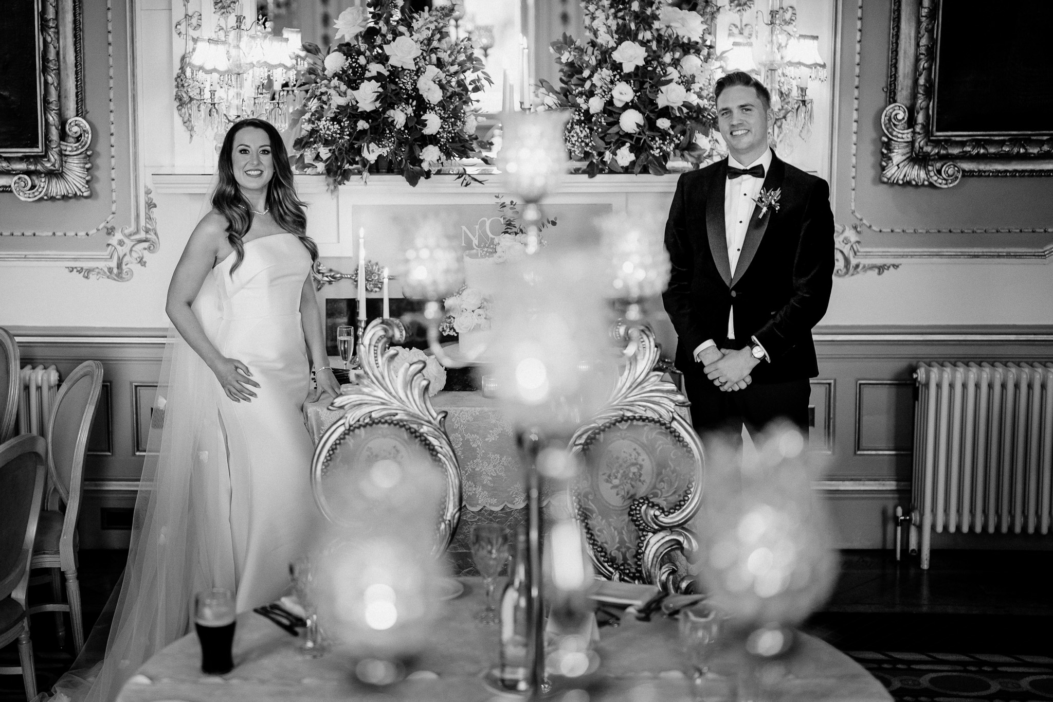 Bride and groom beside their wedding cake in the Dining Room at Markree Castle