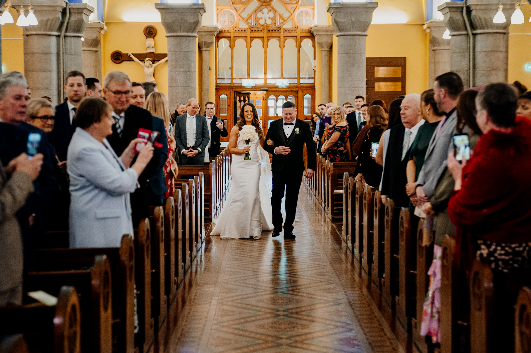 Groom greeting wedding guests inside Sligo Cathedral
