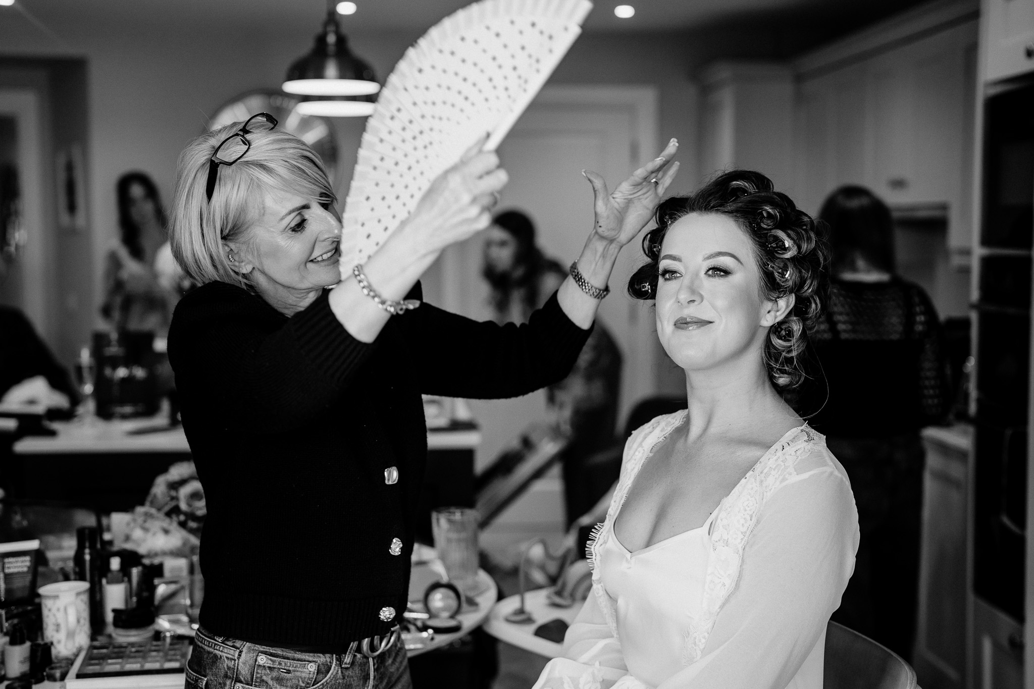 Black and white photograph of bridal makeup during wedding preparations