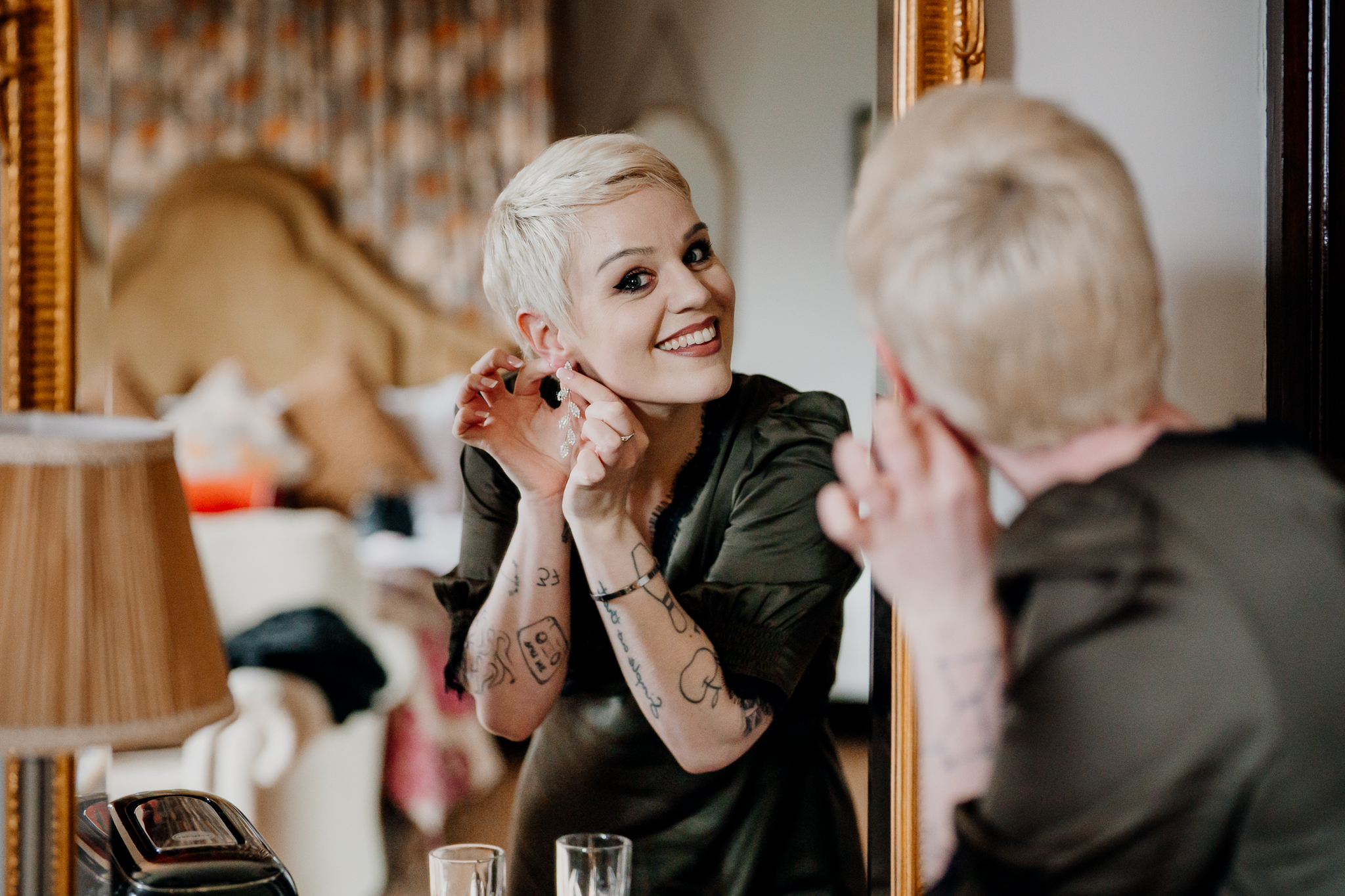 Meagan getting ready beside an ornate mirror in the Johnny Cash Room at Markree Castle