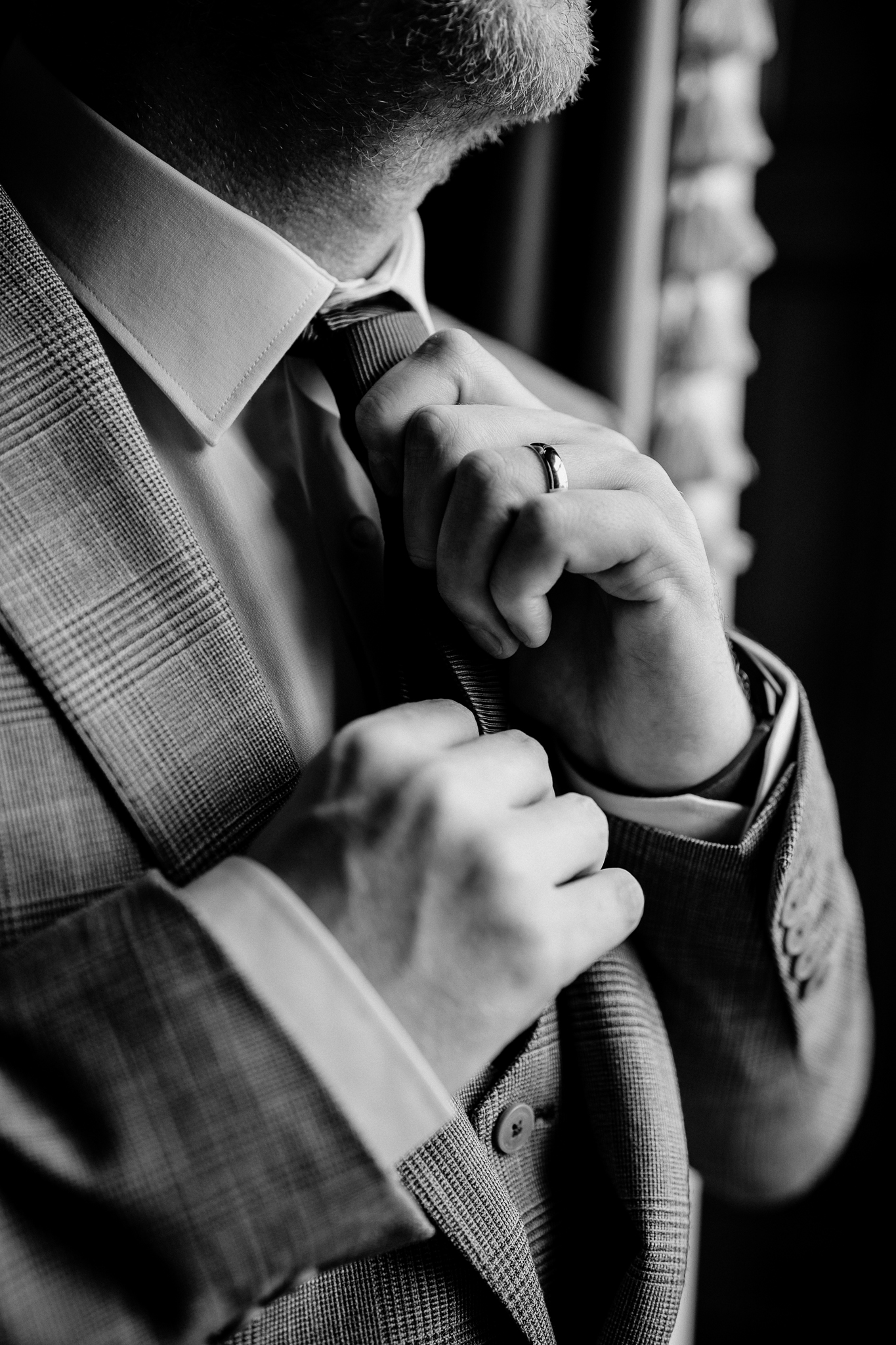 Close-up of the groom adjusting his wedding jacket during preparations at Markree Castle