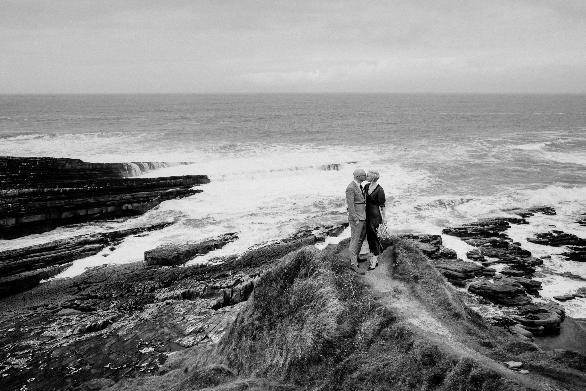 Black and white wedding photography on the rocky Atlantic coastline of Mullaghmore Head in Ireland