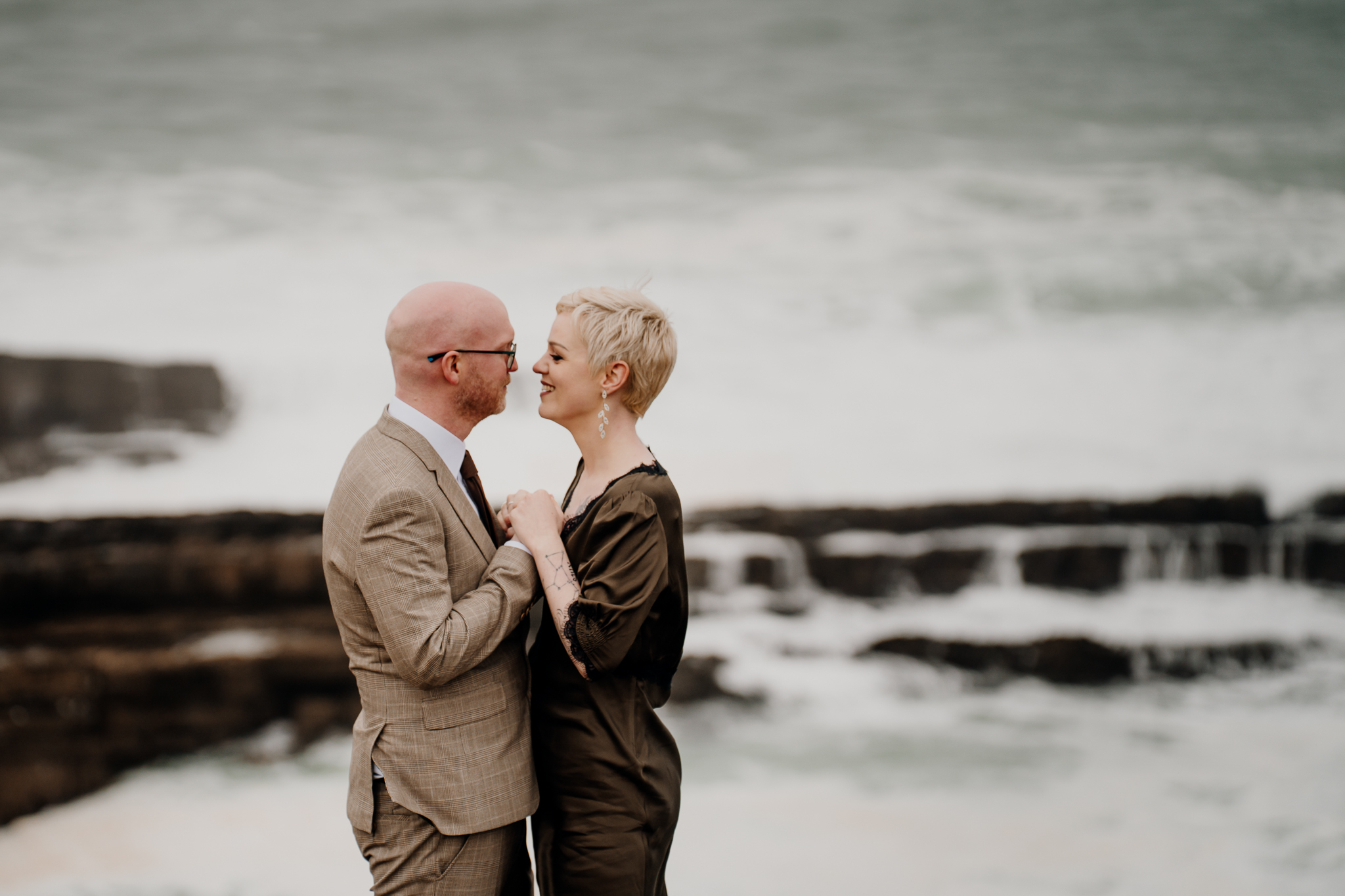 Intimate wedding couple kissing with the Atlantic Ocean behind them at Mullaghmore Head Sligo