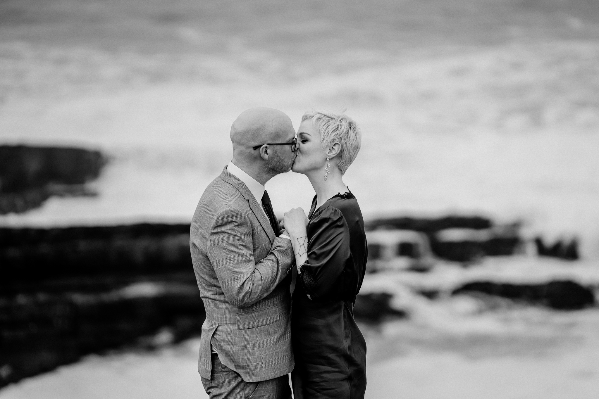 Black and white close-up of a newly married couple kissing at Mullaghmore Head in Sligo