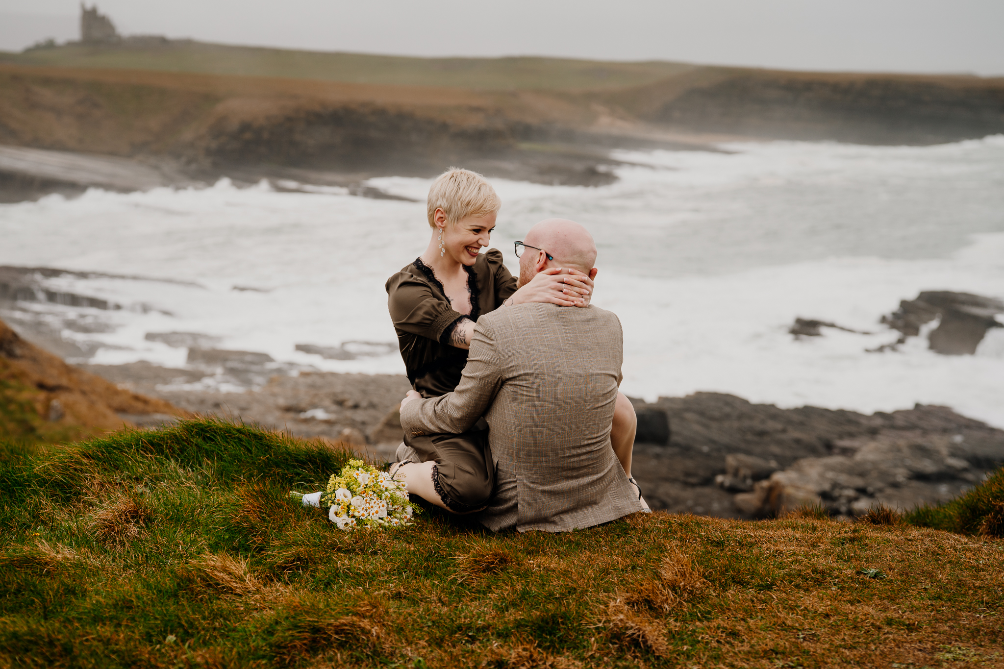 Intimate wedding couple embracing on the grassy cliffs overlooking the Atlantic at Mullaghmore