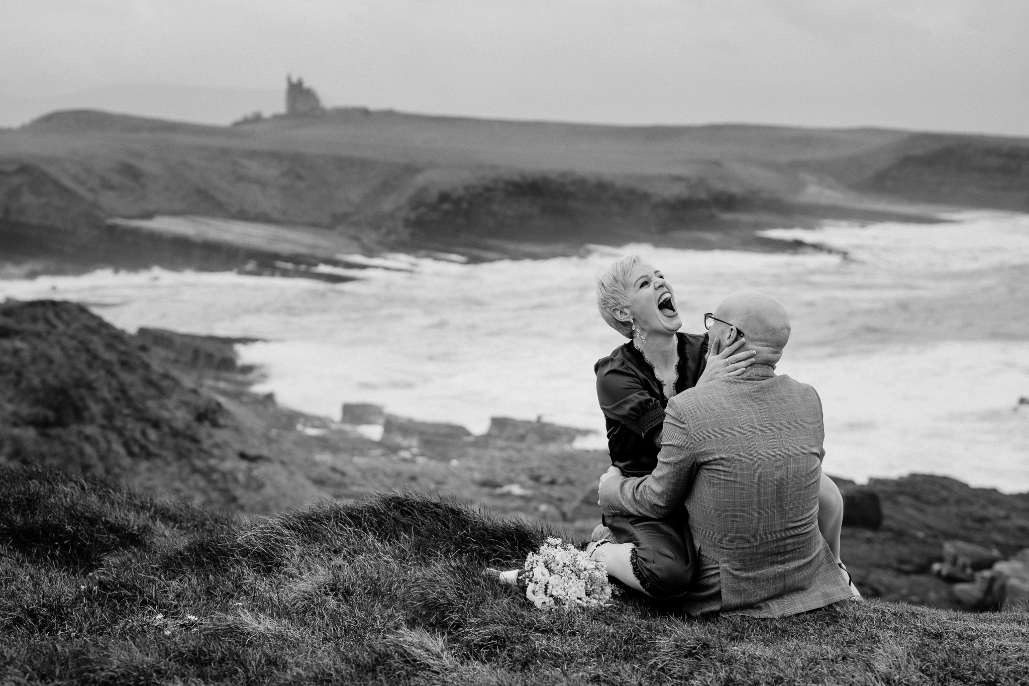 Black and white wedding portrait at Mullaghmore Head with Classiebawn Castle in the distance