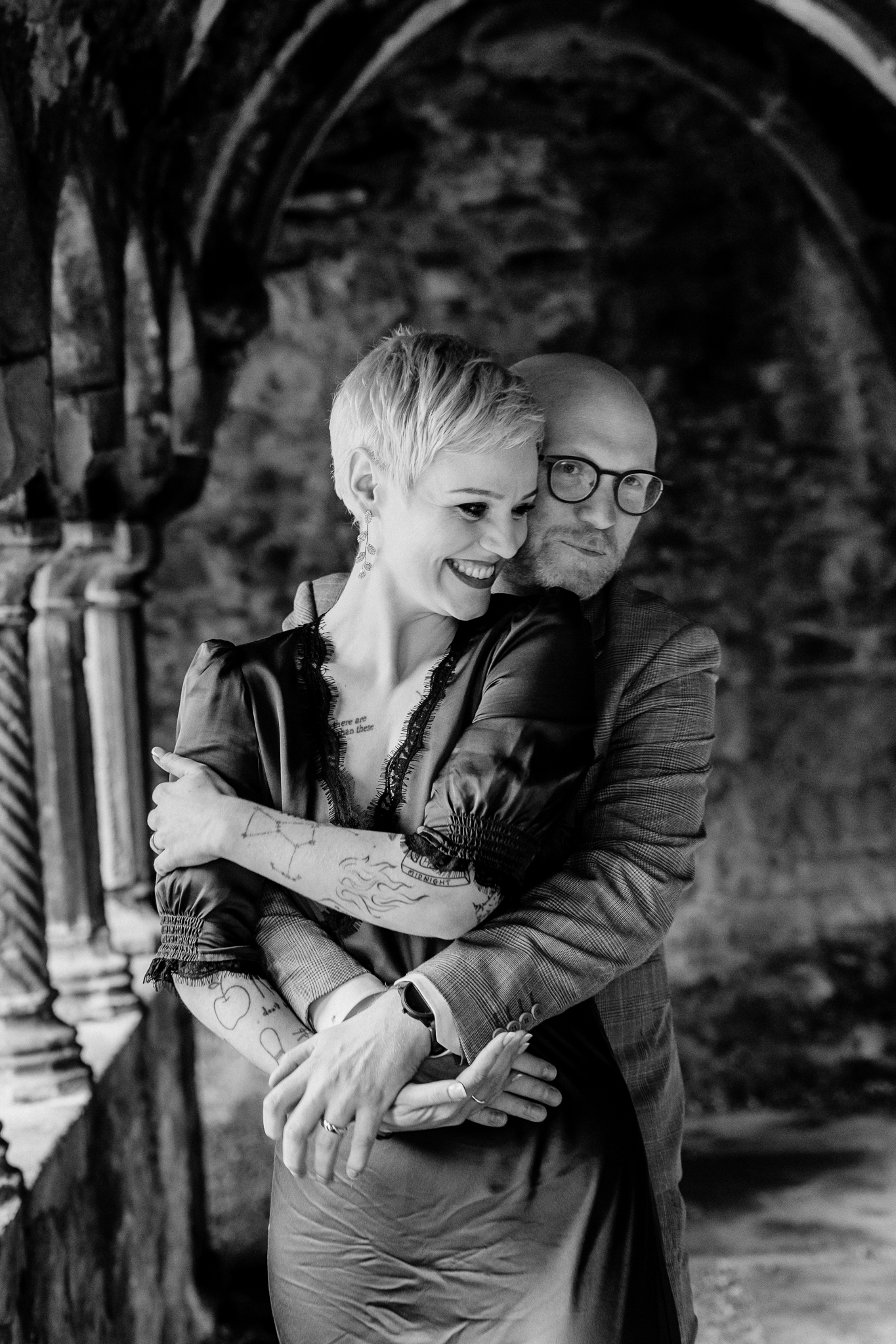 Black and white portrait of newlyweds embracing at the historic Sligo Abbey