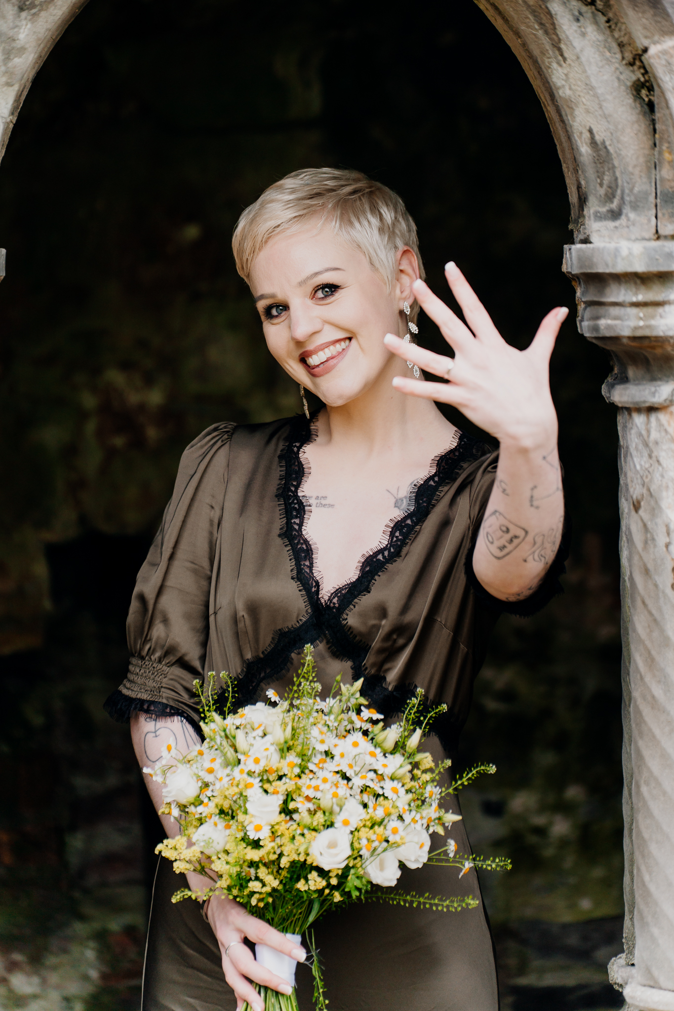 Smiling bride showing her wedding ring during a portrait session at Sligo Abbey