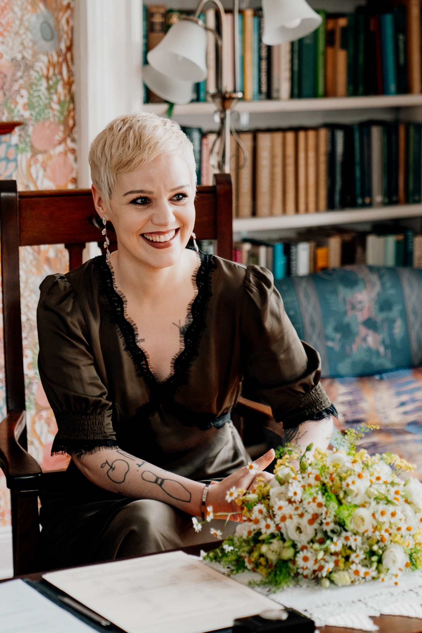 Bride Meagan smiling beside bookshelves inside the Yeats Building in Sligo