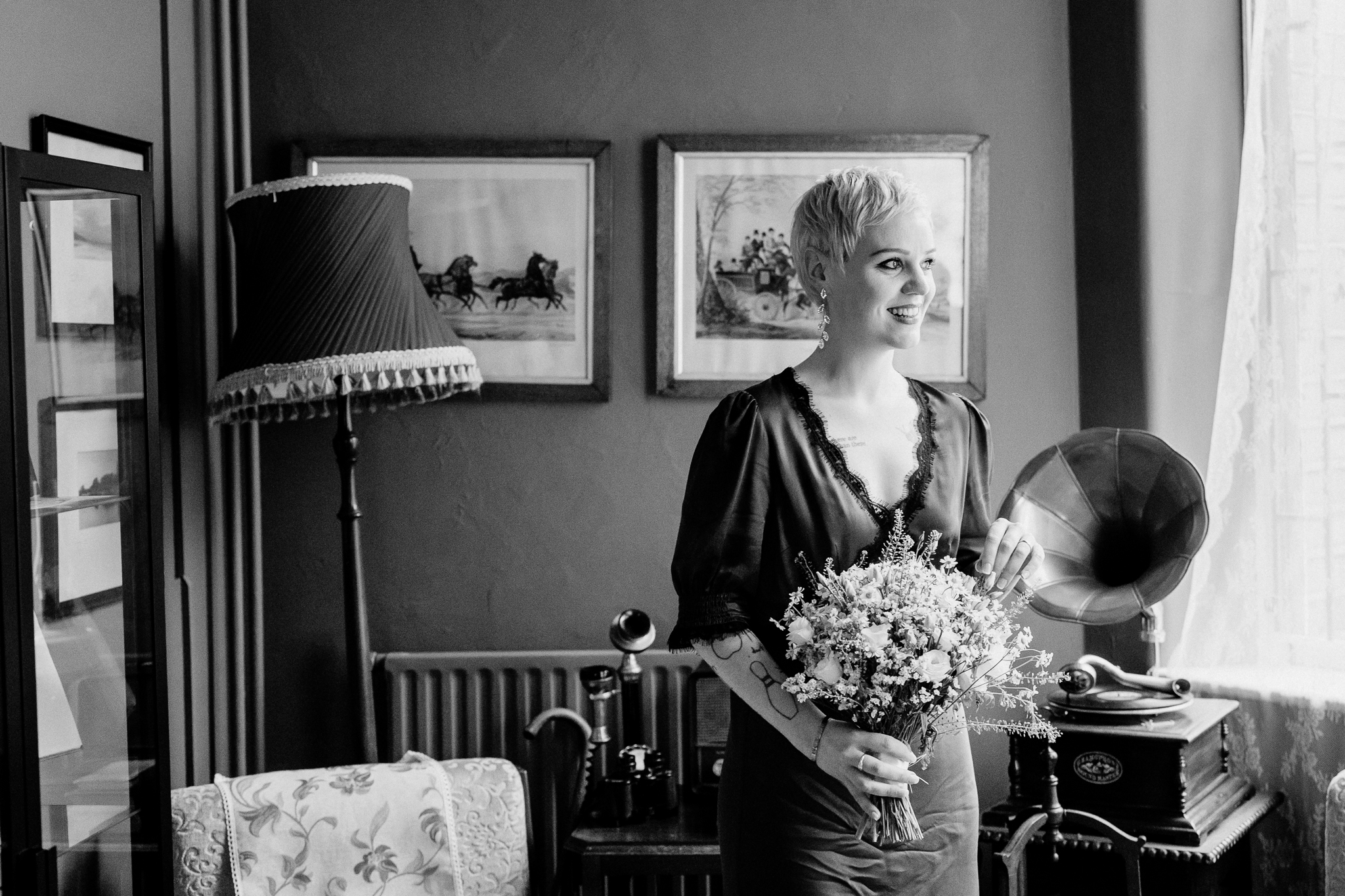 Black and white bridal portrait beside a window inside the Yeats Building