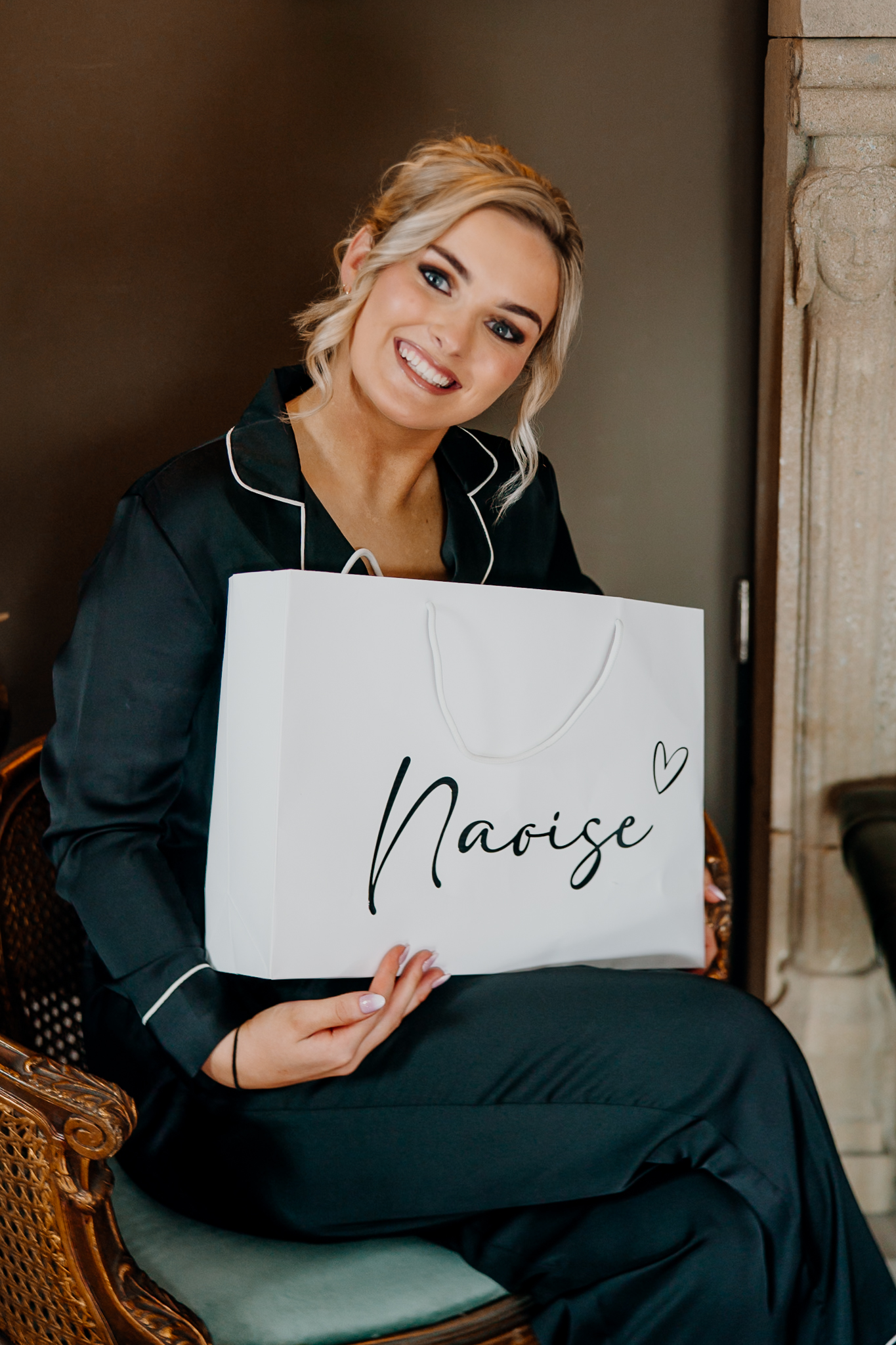 Bridesmaid holding a gift during wedding preparations at Markree Castle