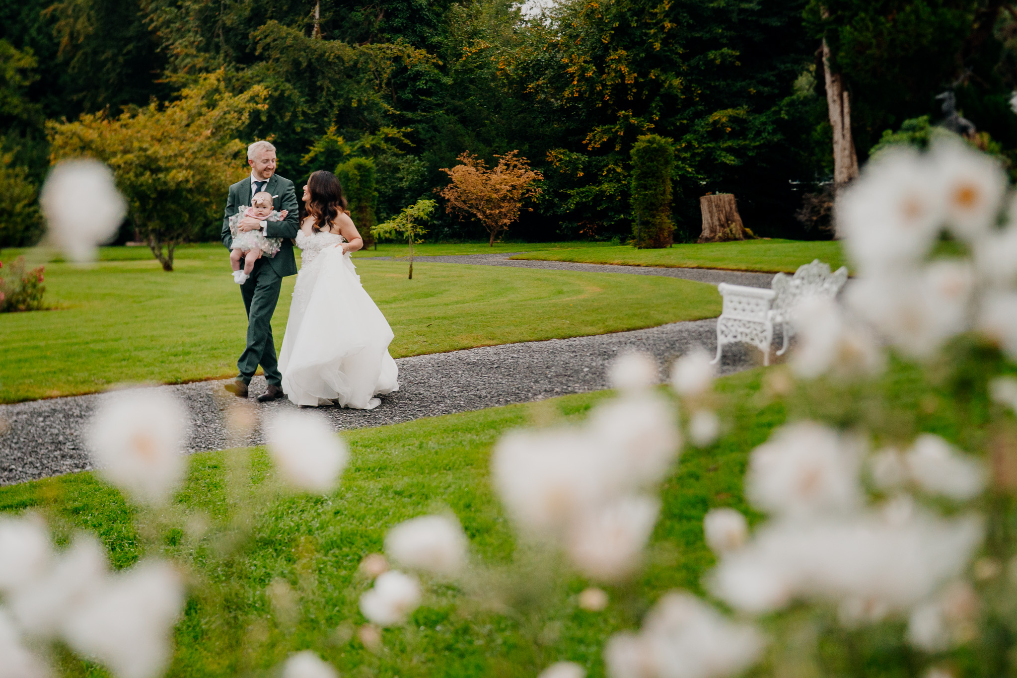 Bride and groom walking through Markree Castle gardens after wedding portraits
