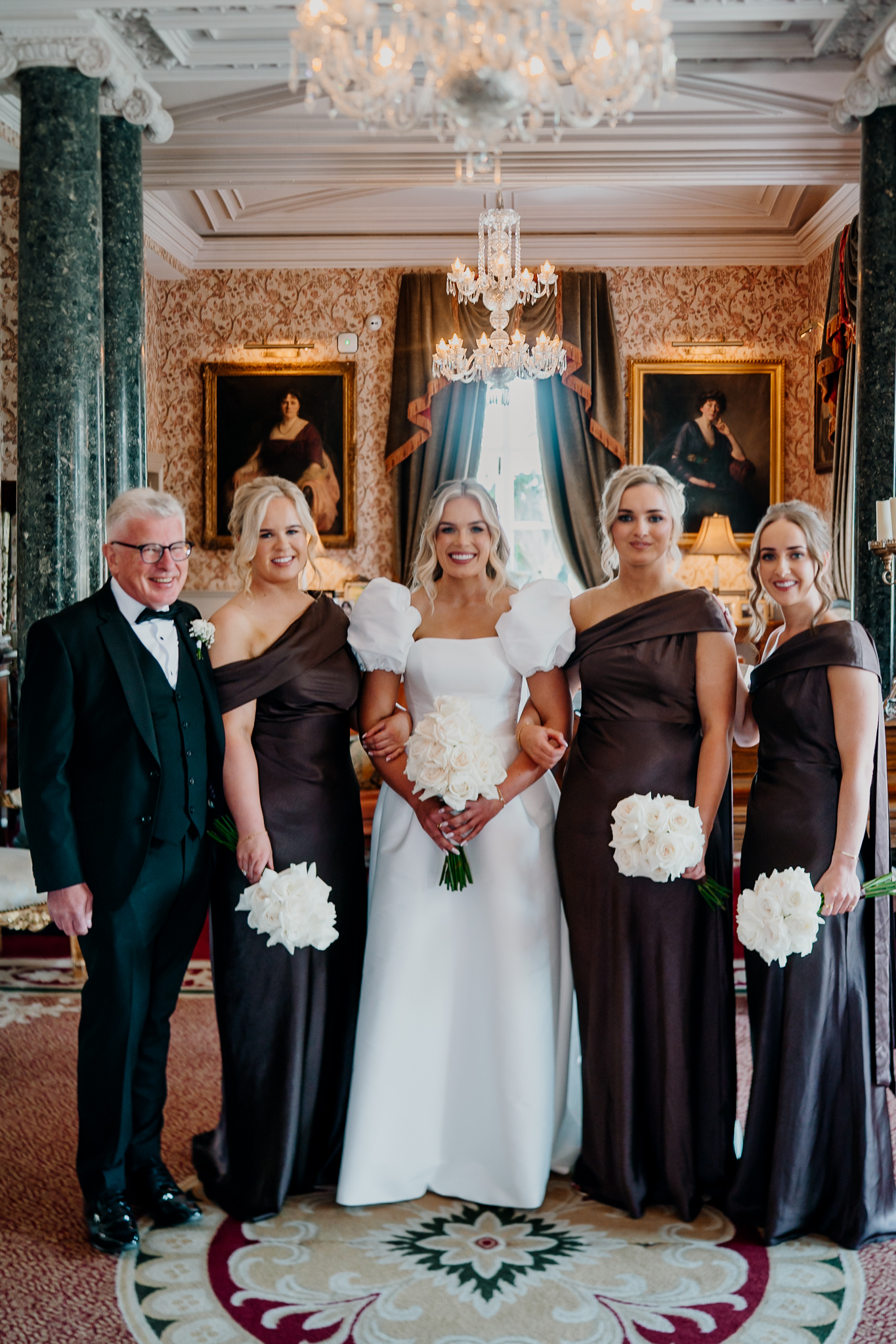 Bride Caoimhe with her bridal party and father in the Grand Hall at Markree Castle