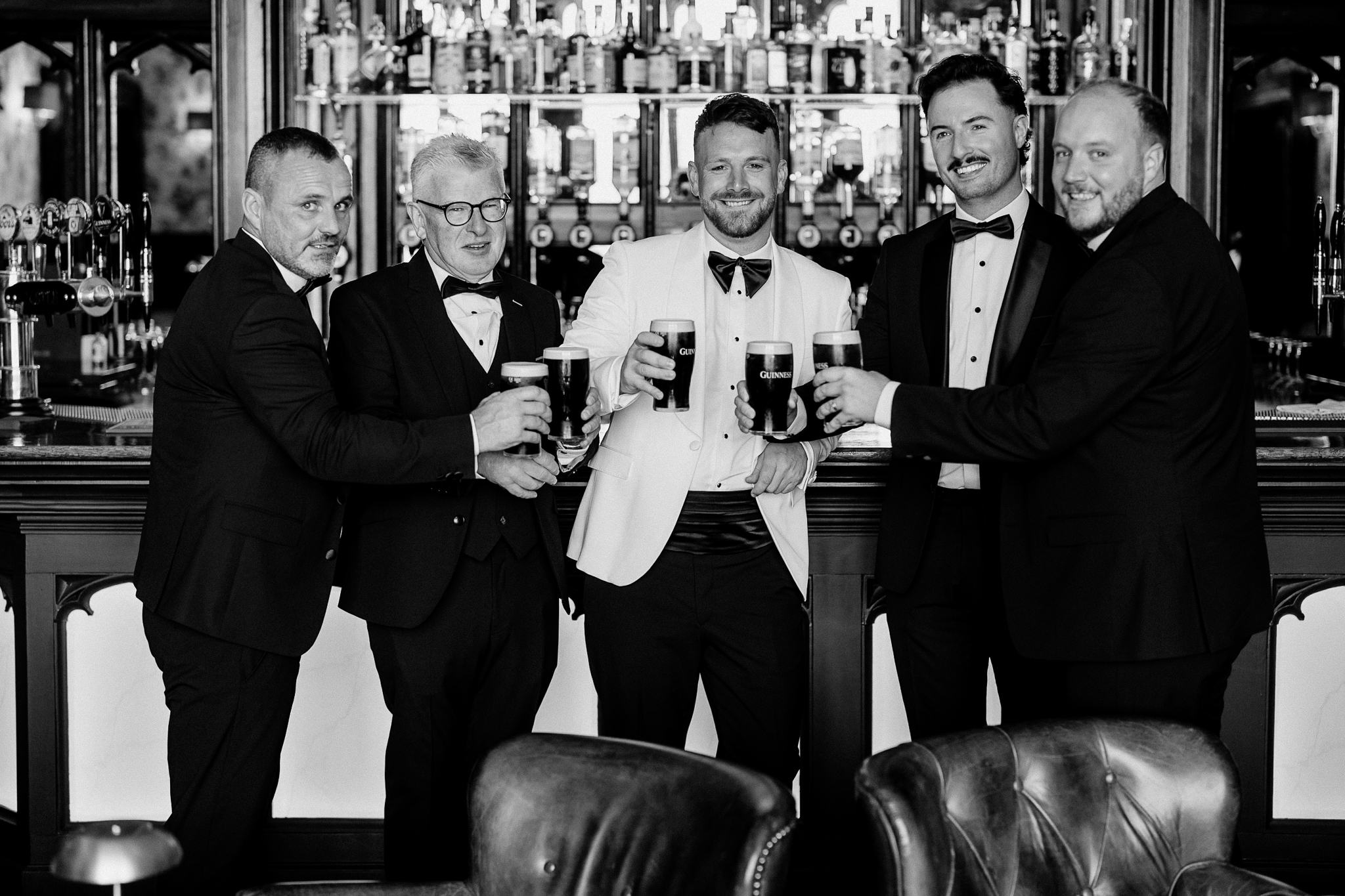 Groom and groomsmen having Guinness at the bar in Markree Castle