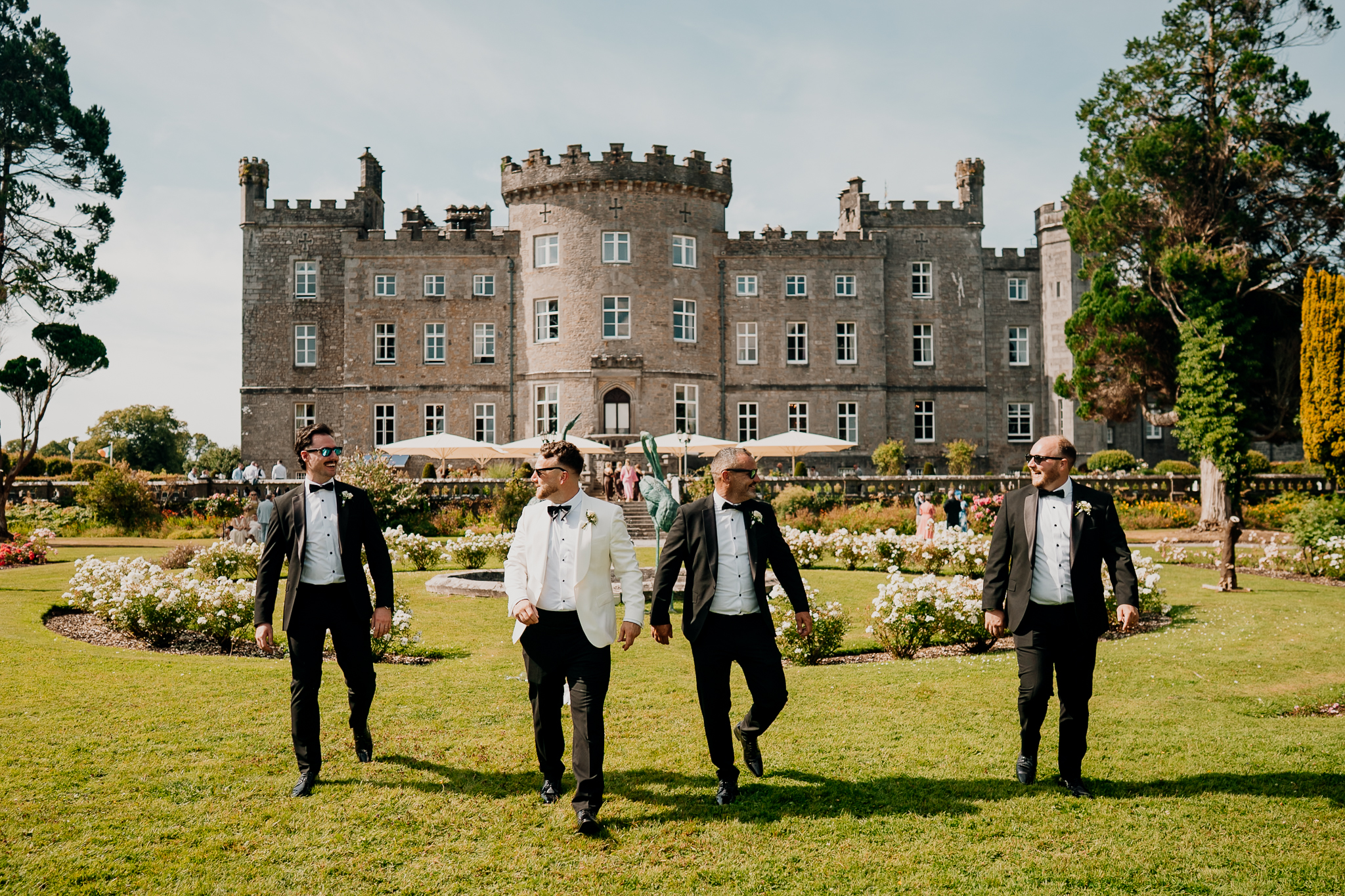 Groom and groomsmen walking through the woodland at Markree Castle
