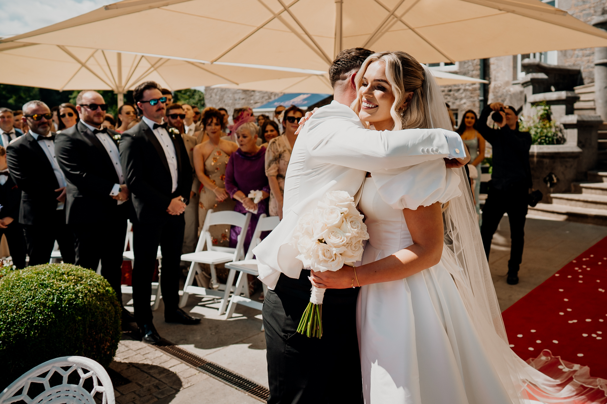 Bride Caoimhe embracing a guest during her outdoor wedding ceremony at Markree Castle