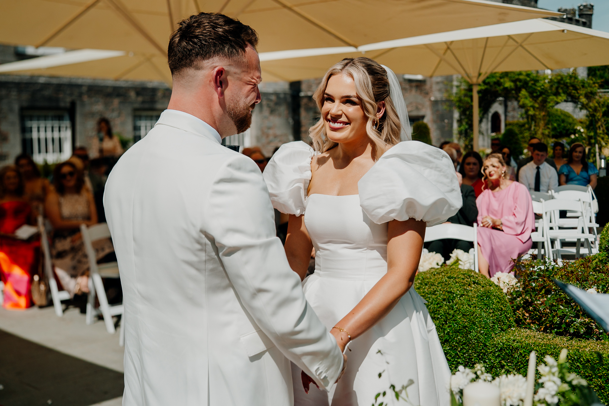 Bride and groom smiling during their outdoor wedding ceremony at Markree Castle