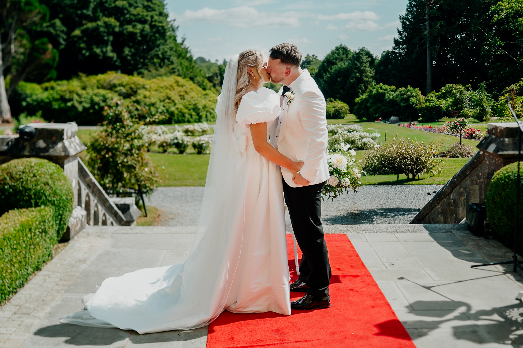 Bride and groom kissing after their outdoor wedding ceremony at Markree Castle