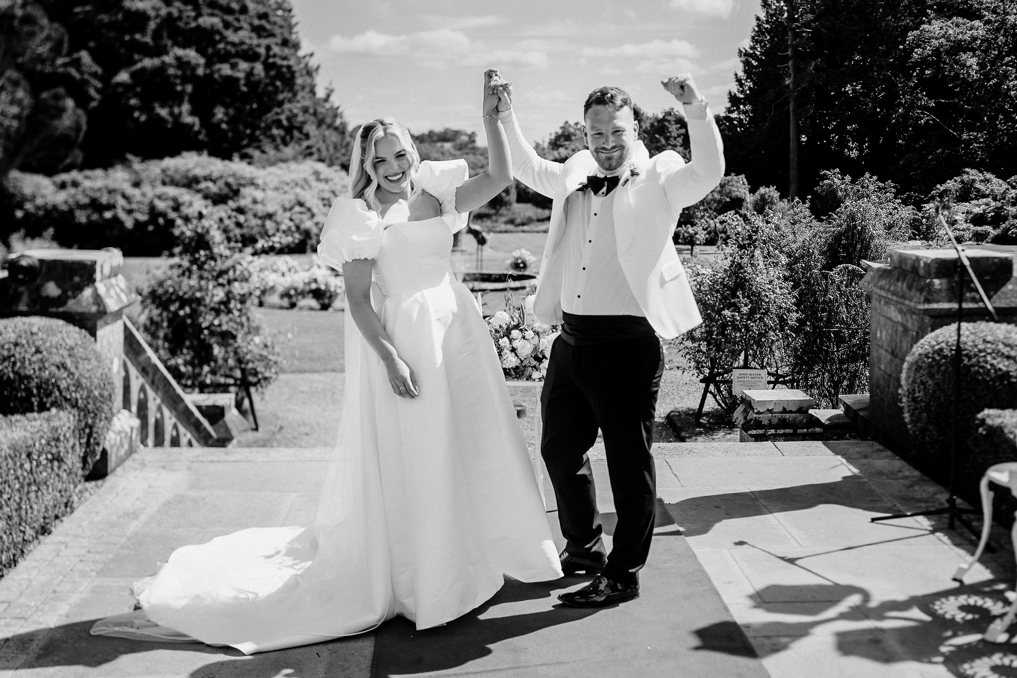 Newlyweds celebrating after their outdoor wedding ceremony at Markree Castle