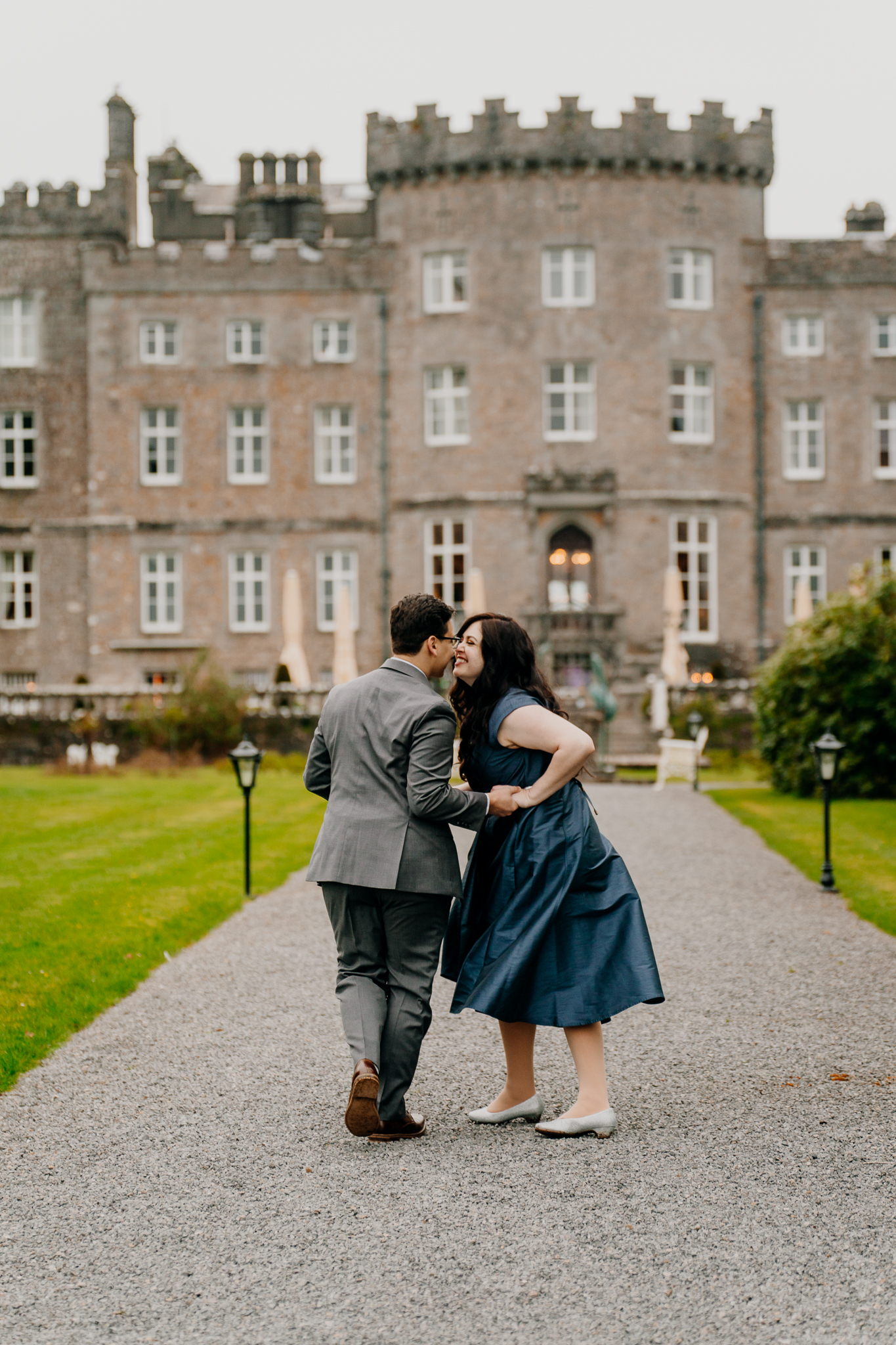 Couple kissing in front of Markree Castle during their romantic engagement photography session in County Sligo, Ireland.
