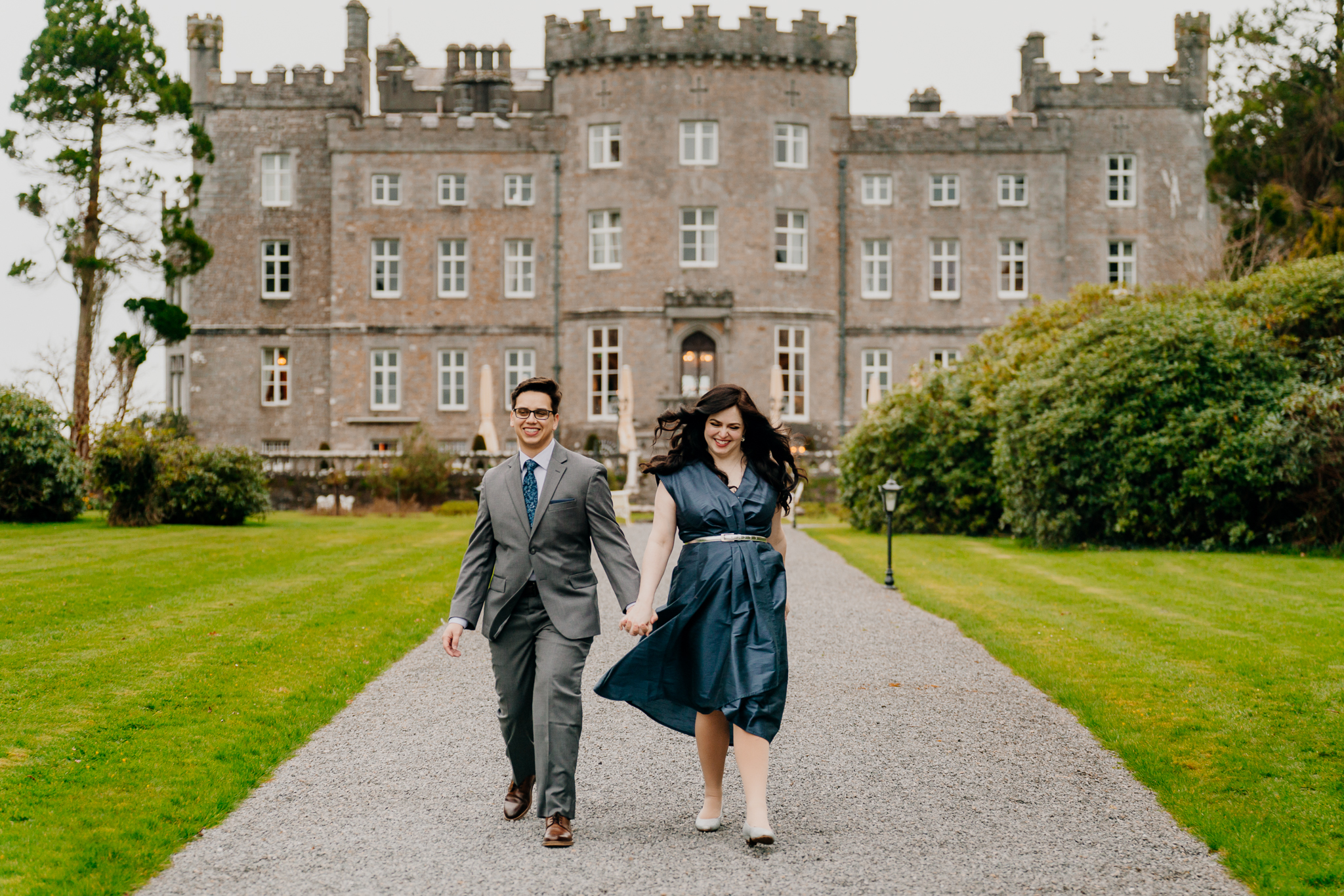 Engaged couple standing together on the lawn in front of Markree Castle during their surprise proposal photography experience in Ireland.
