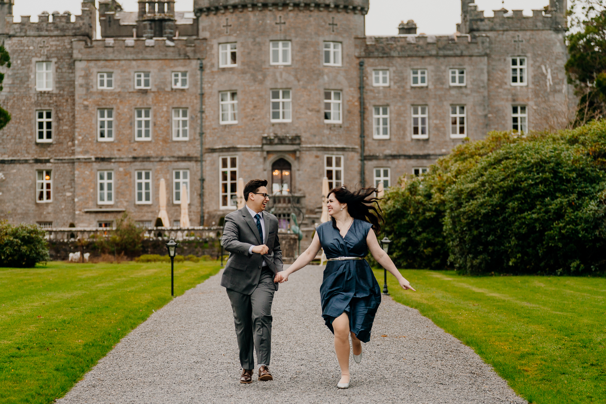 Couple enjoying a relaxed engagement photography session in the gardens of Markree Castle, with the historic Irish castle behind them.