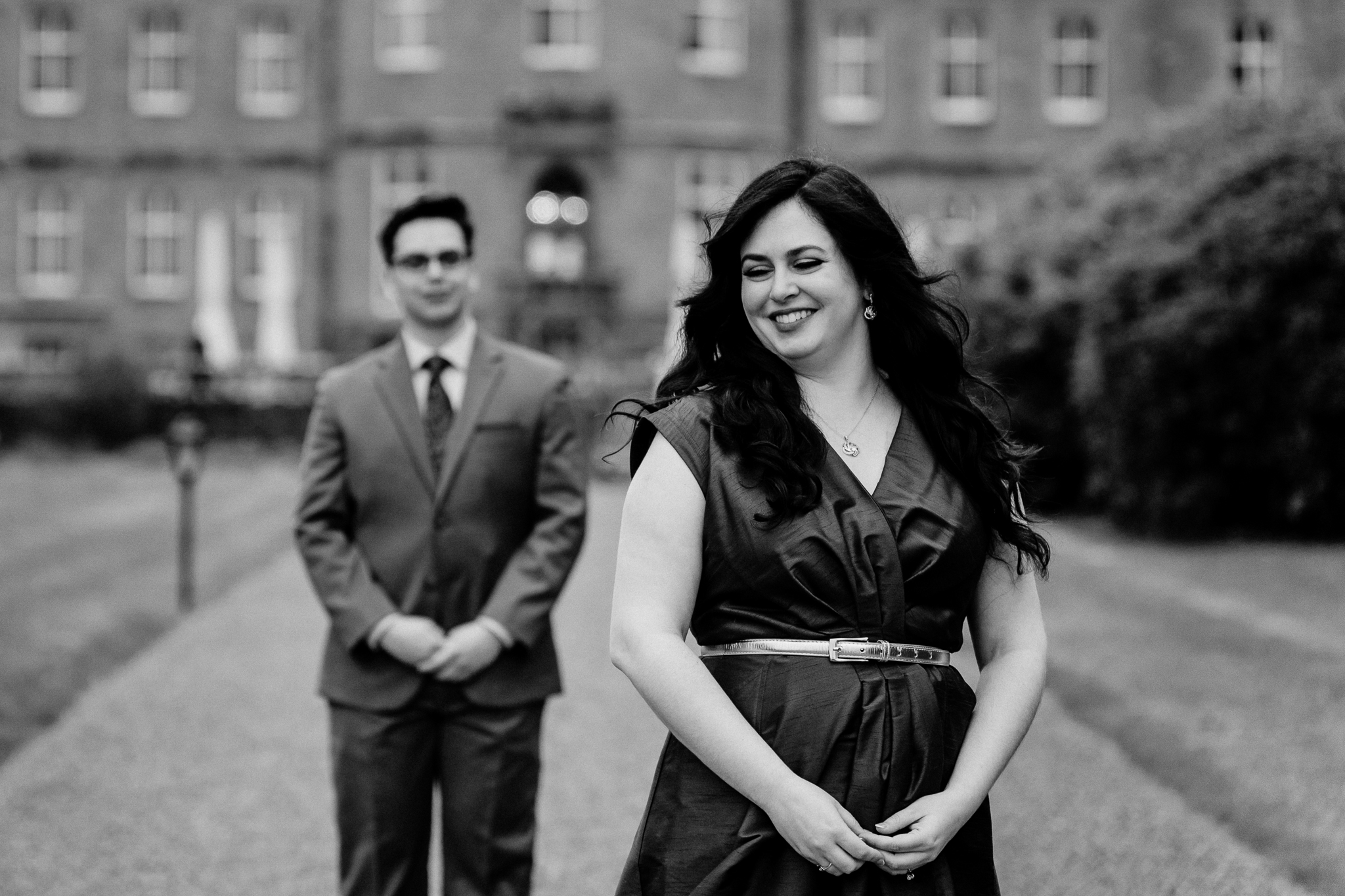 Black-and-white portrait of a newly engaged couple walking together in front of Markree Castle in County Sligo, Ireland.