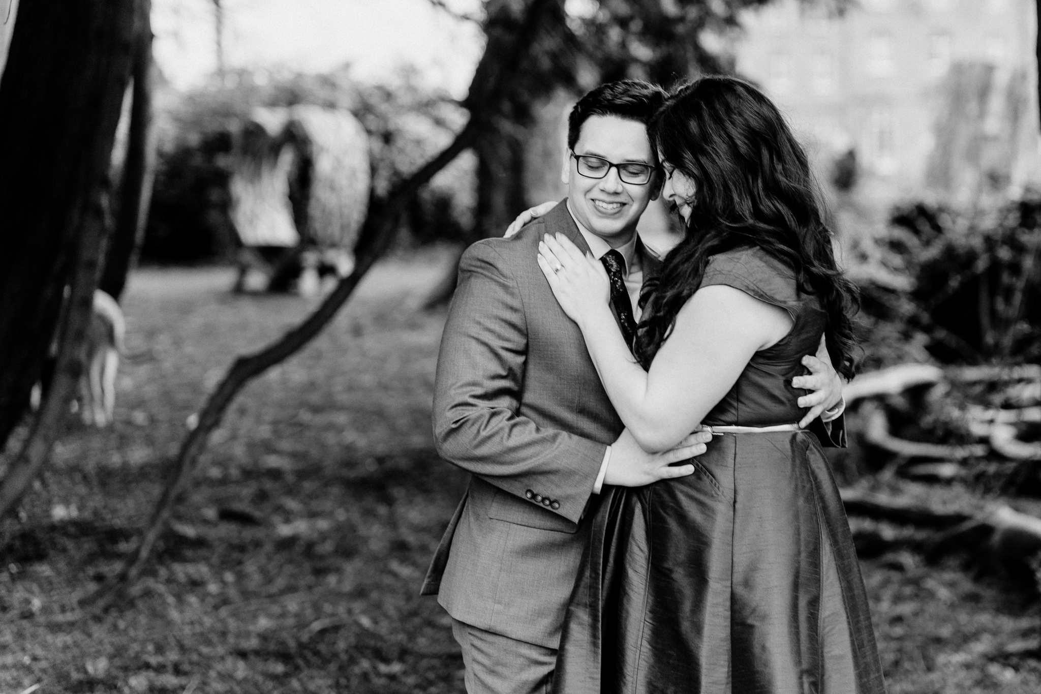 Black-and-white portrait of a newly engaged couple embracing during a romantic woodland engagement session at Markree Castle, Ireland.