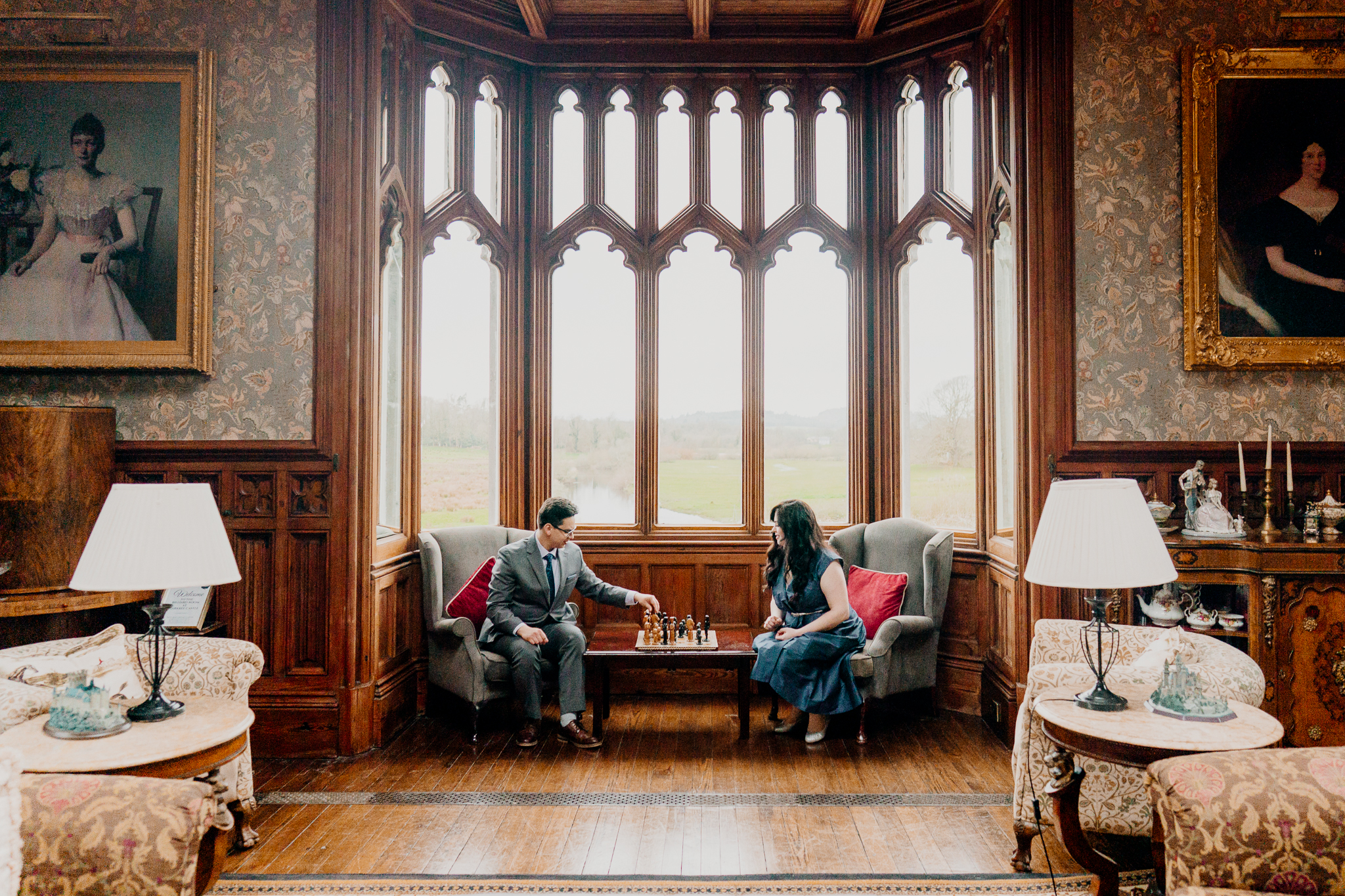 Newly engaged couple playing chess together in the Billiard Room at Markree Castle, Sligo, during their romantic engagement stay.