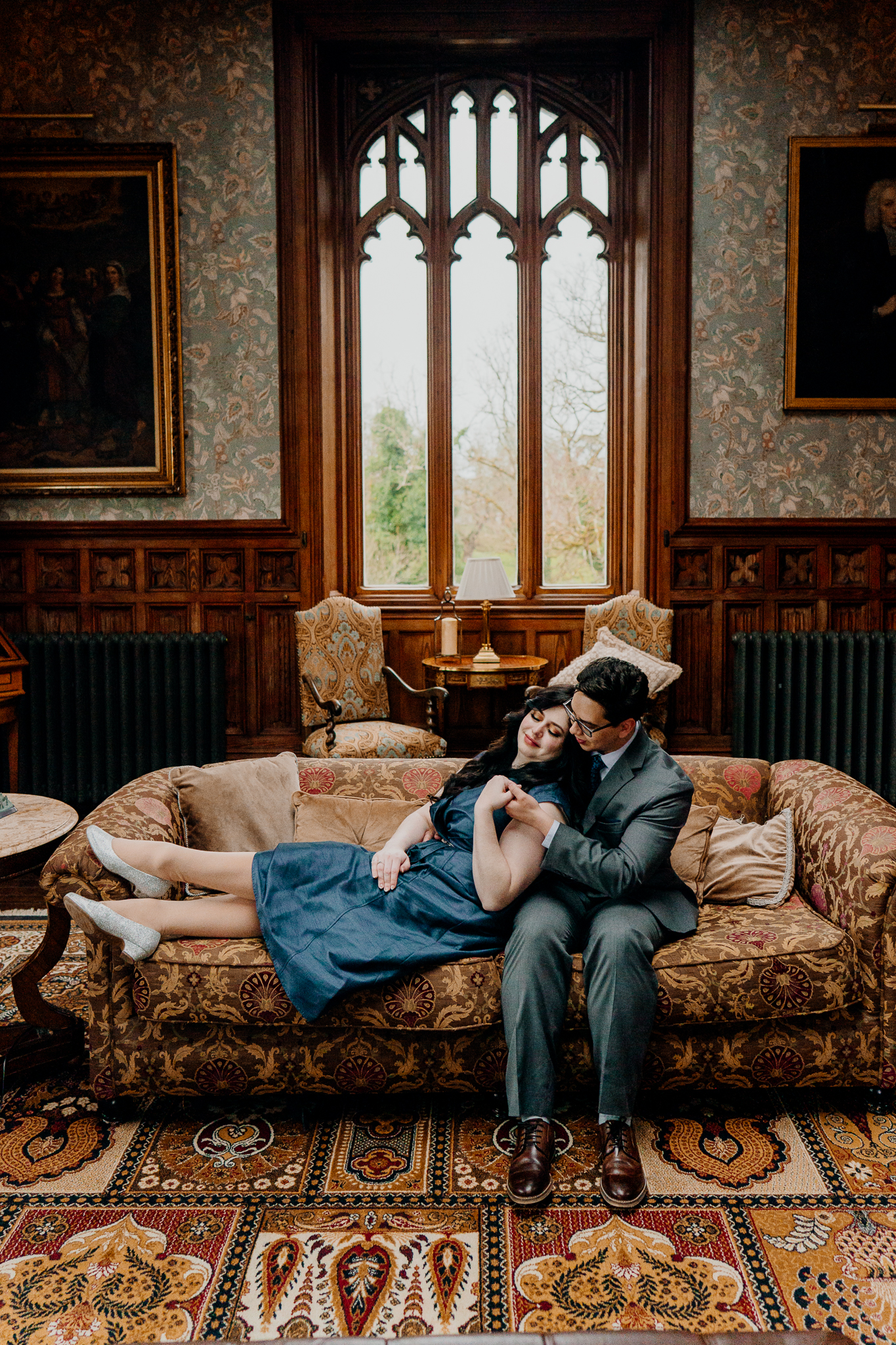 Newly engaged couple relaxing together on a sofa in the Billiard Room at Markree Castle after their surprise proposal.