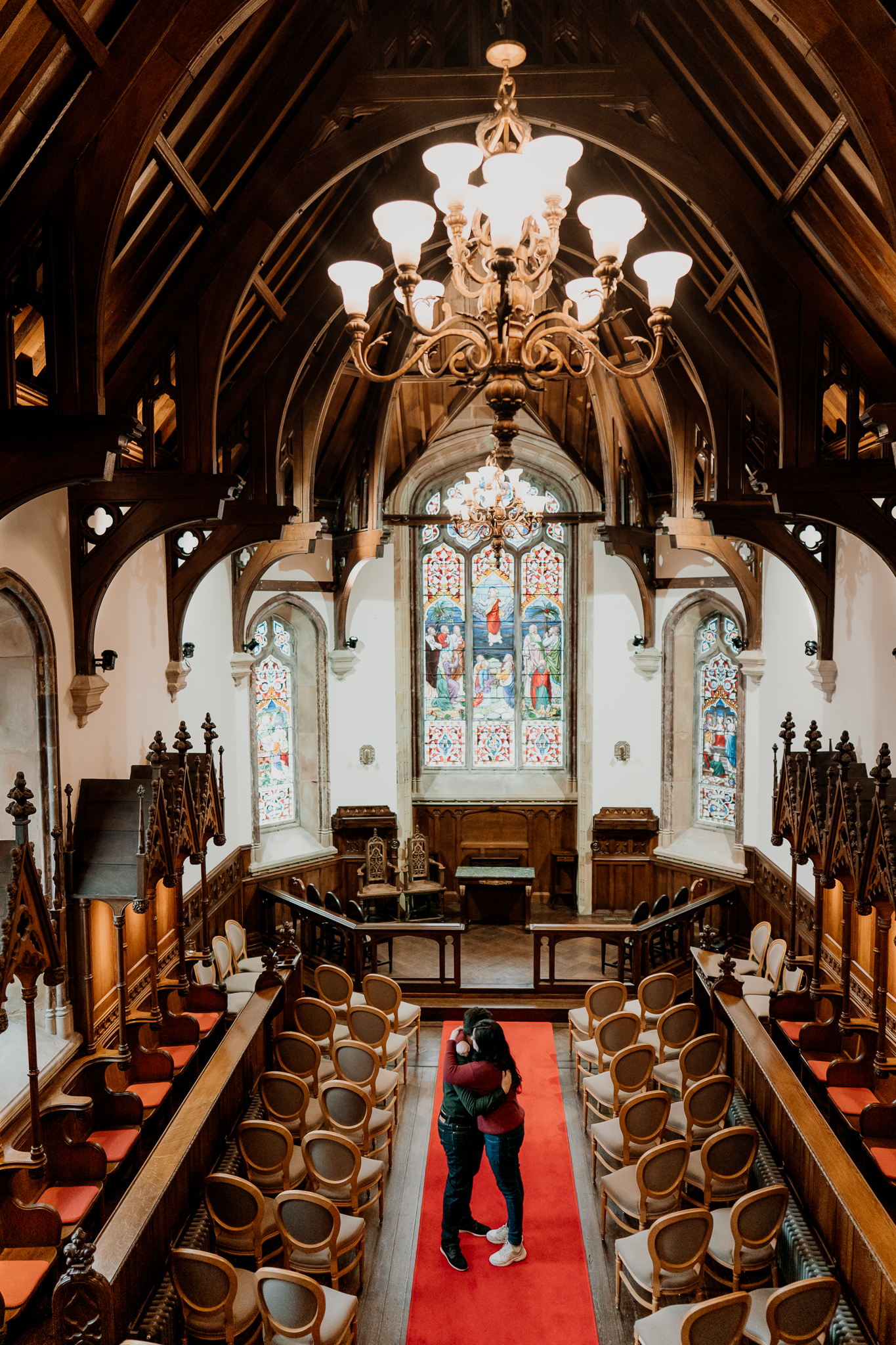 Markree Castle chapel interior with stained-glass windows and wooden pews, the setting for a romantic surprise marriage proposal in Sligo, Ireland.