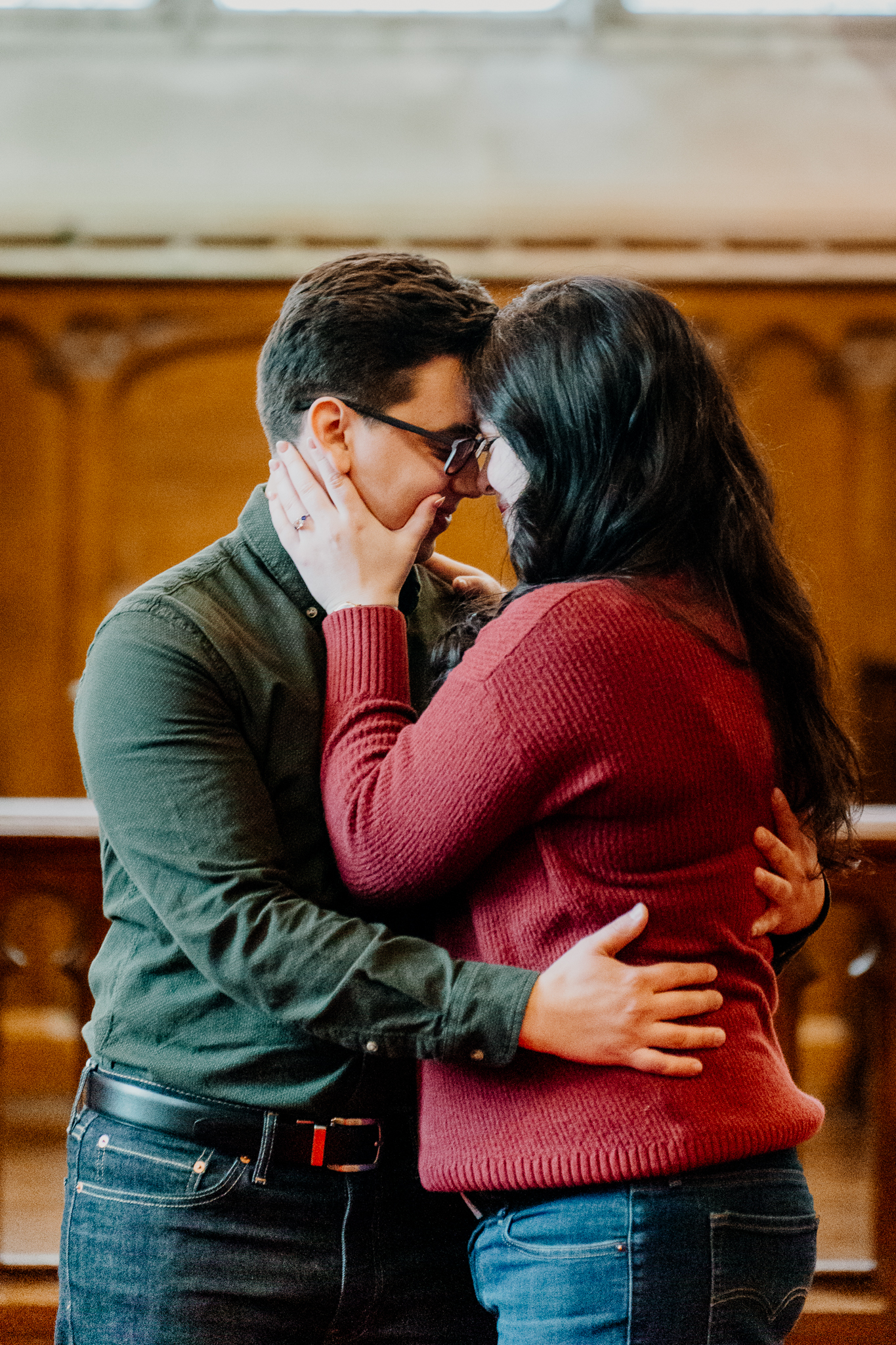 Newly engaged couple embracing inside Markree Castle chapel after their surprise marriage proposal in Sligo, Ireland.