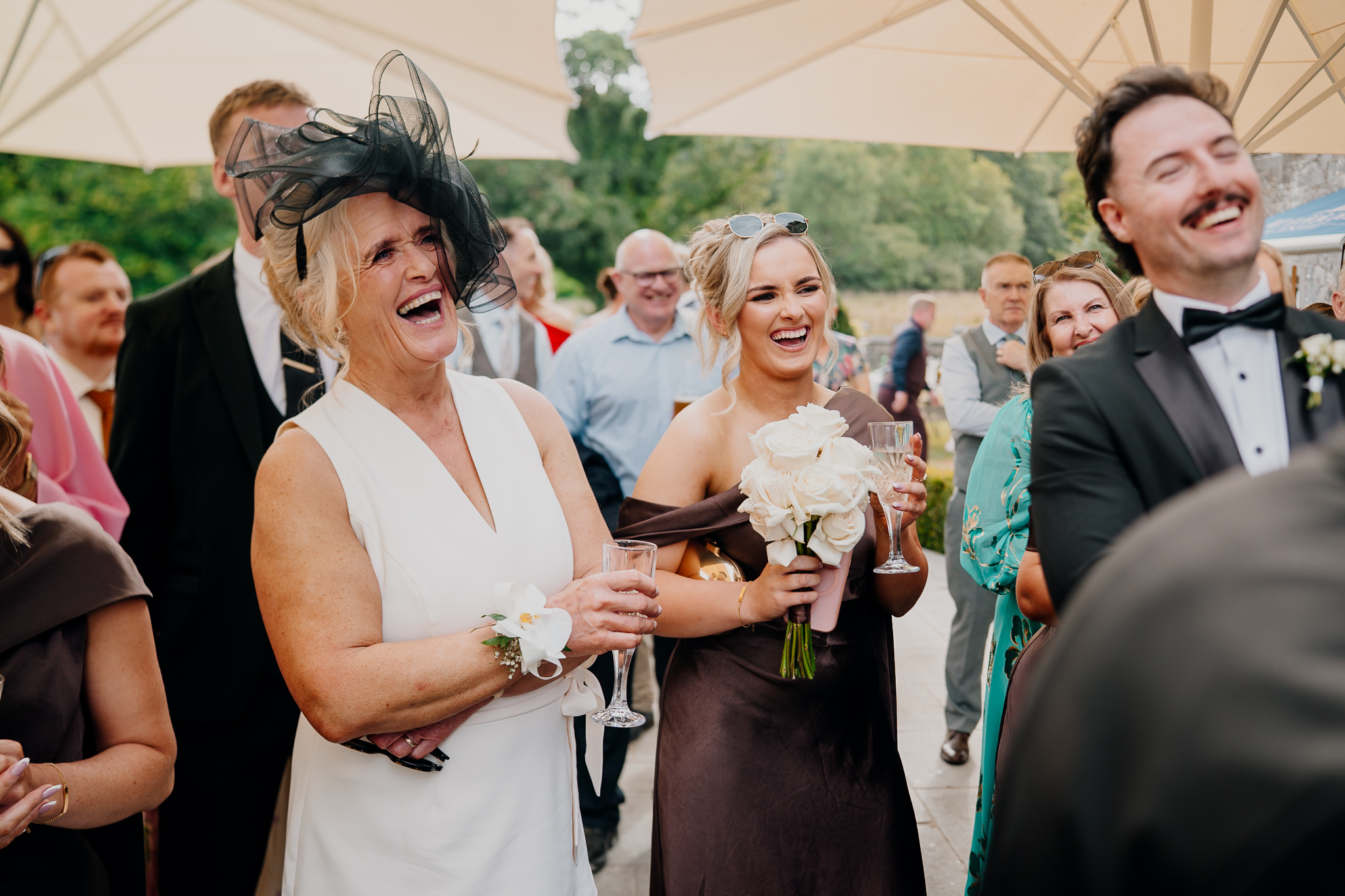 Wedding guests laughing during speeches on the terrace at Markree Castle