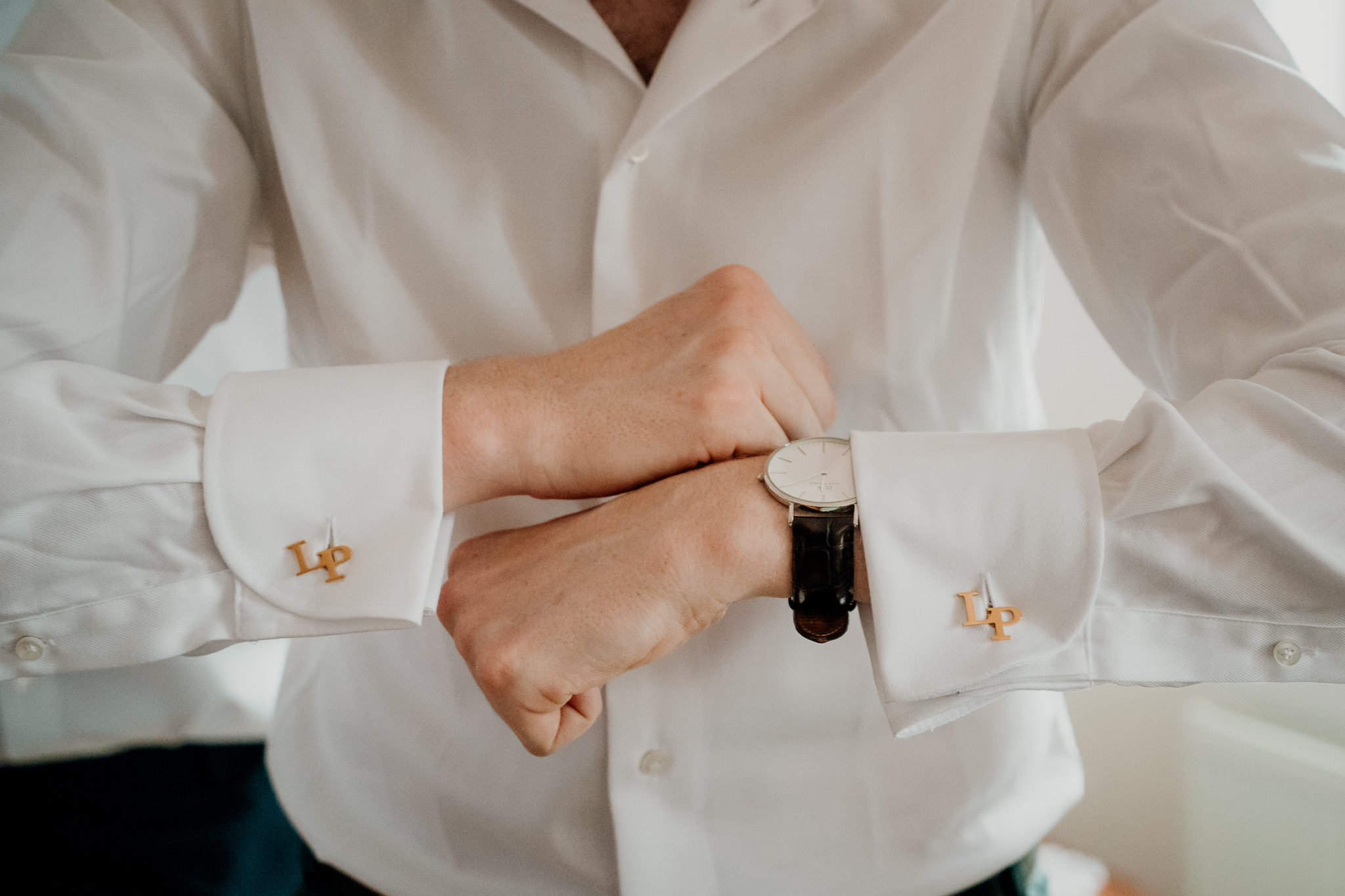 Groom getting ready at his family home on his wedding morning
