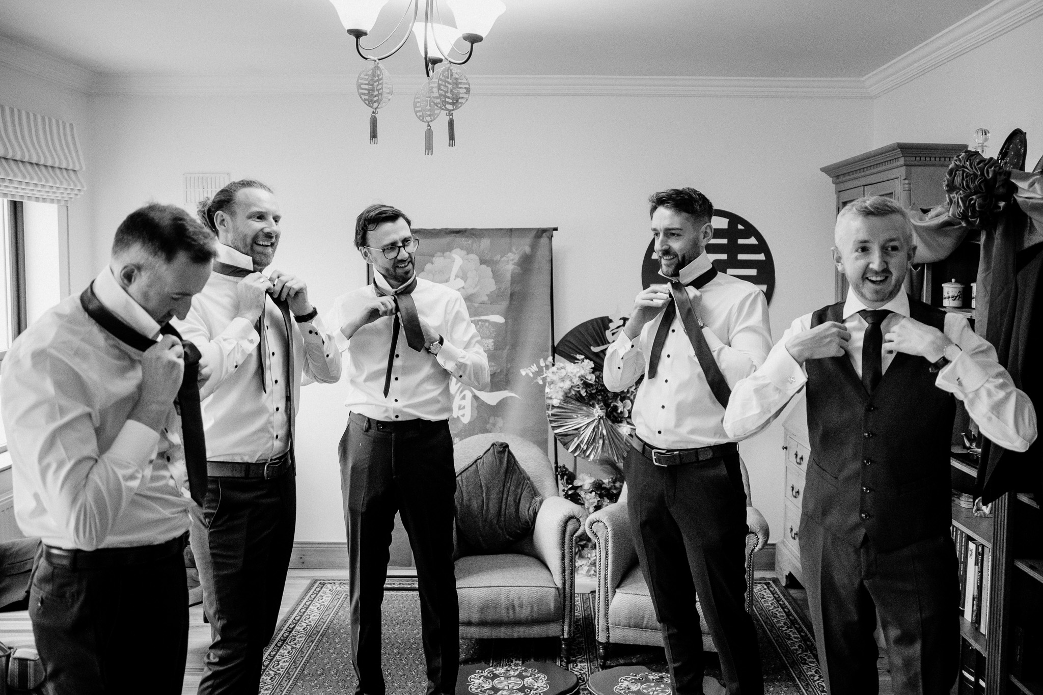 Candid groom portrait during wedding morning preparations