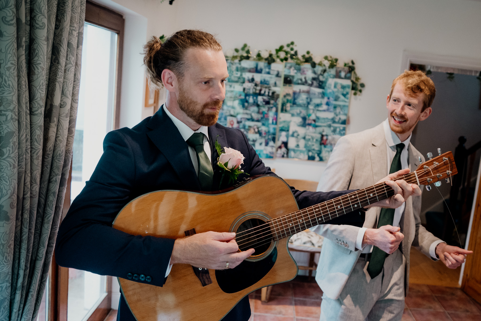 Groom having his outfit adjusted before the wedding ceremony