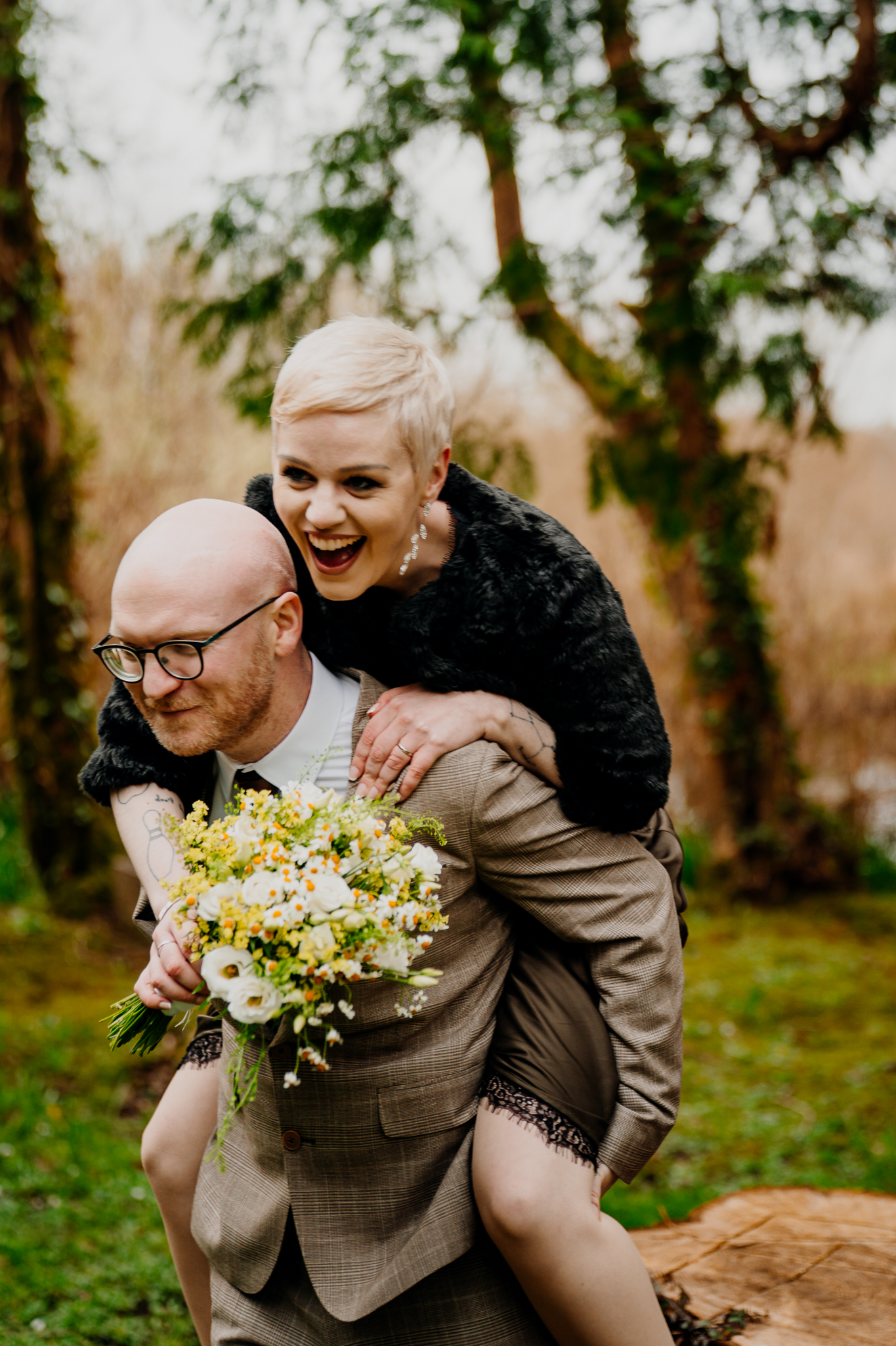 Bride riding on her partner’s back near the Boathouse at Markree Castle in Sligo