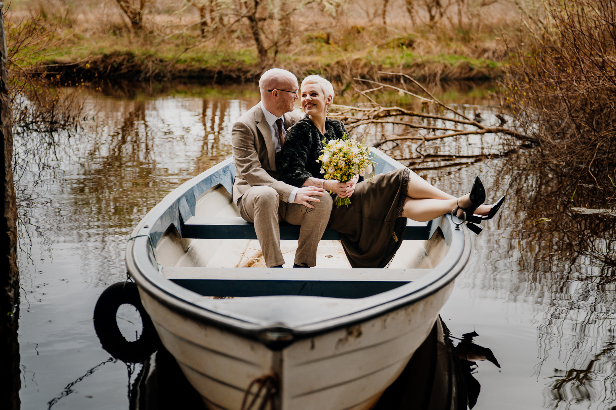 Newly married couple sitting together in a boat at Markree Castle Boathouse in Sligo