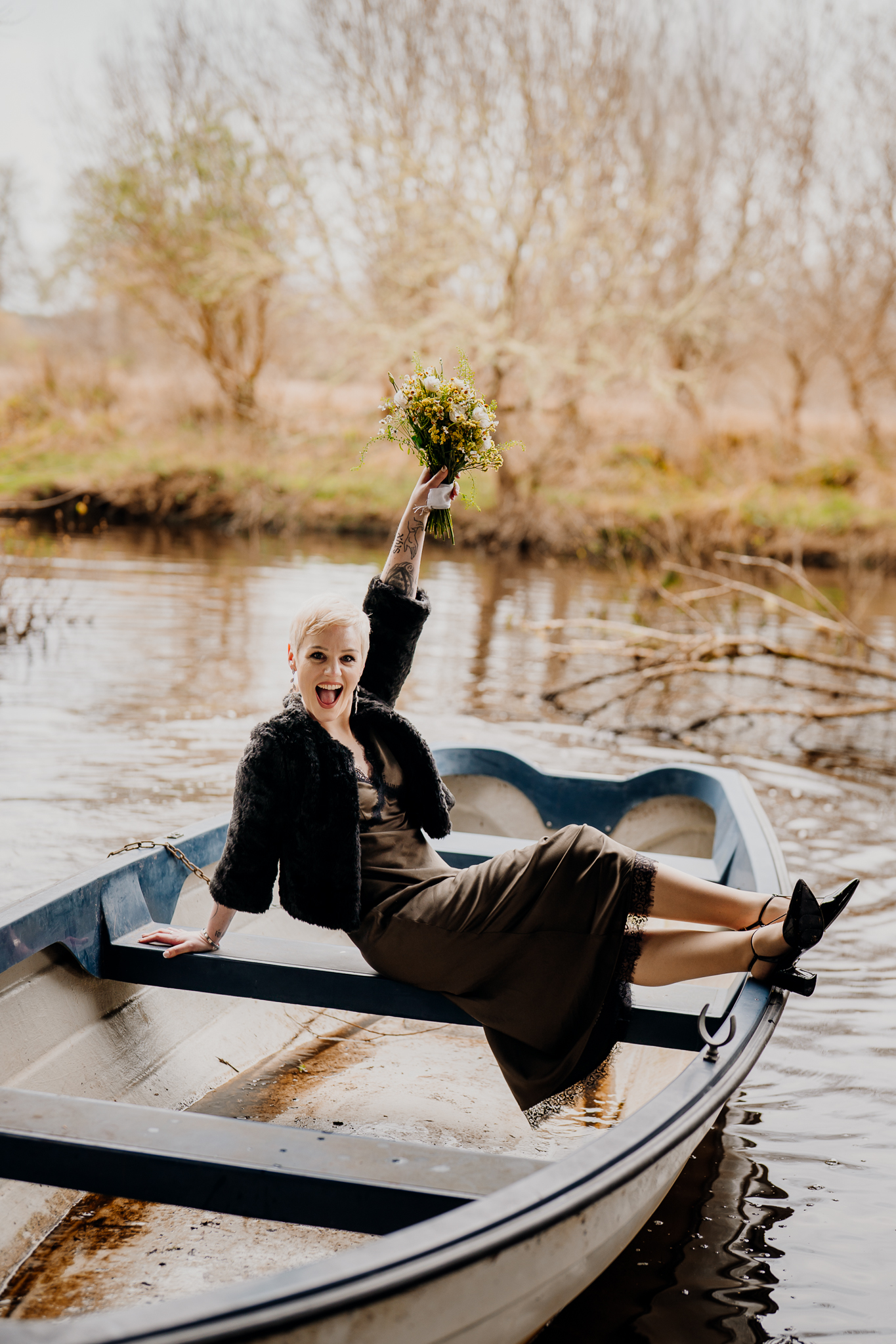 Intimate wedding couple relaxing in a boat on the water at Markree Castle in Ireland