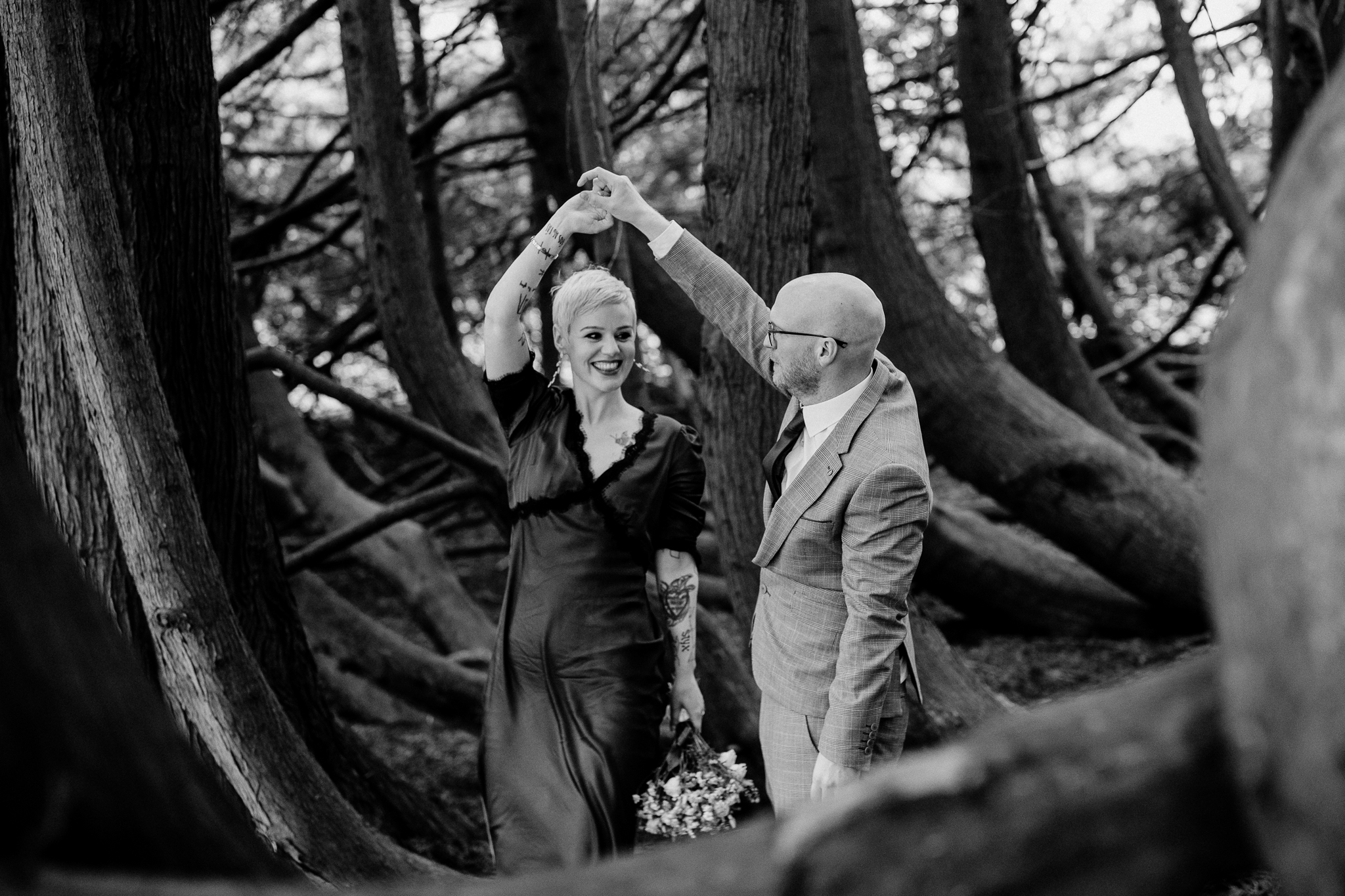 Black and white wedding portrait of a couple among the trees at Markree Castle woodland