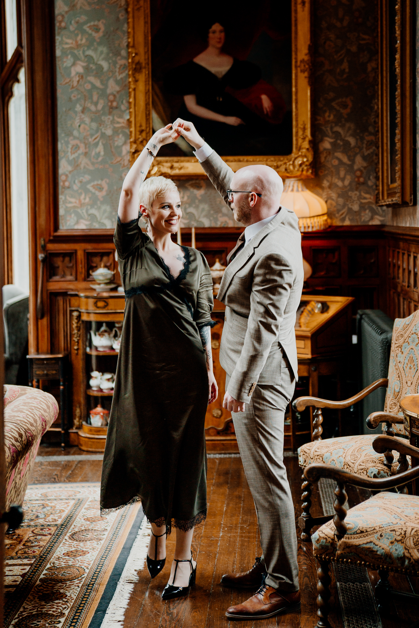 Playful wedding couple dancing together inside the historic Billiard Room at Markree Castle