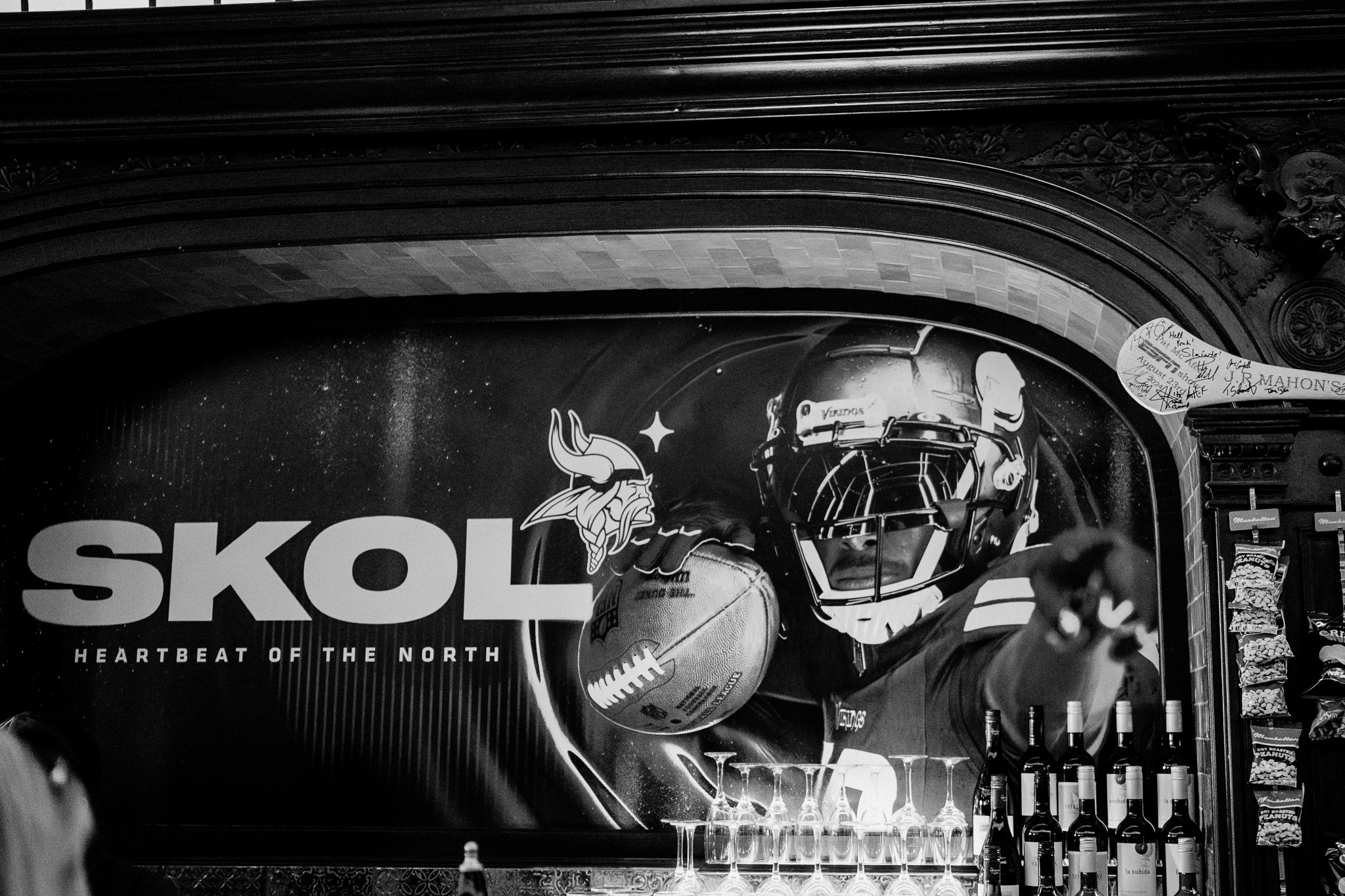 Black and white photograph of a Minnesota Vikings SKOL football display inside J.R. Mahon's Dublin