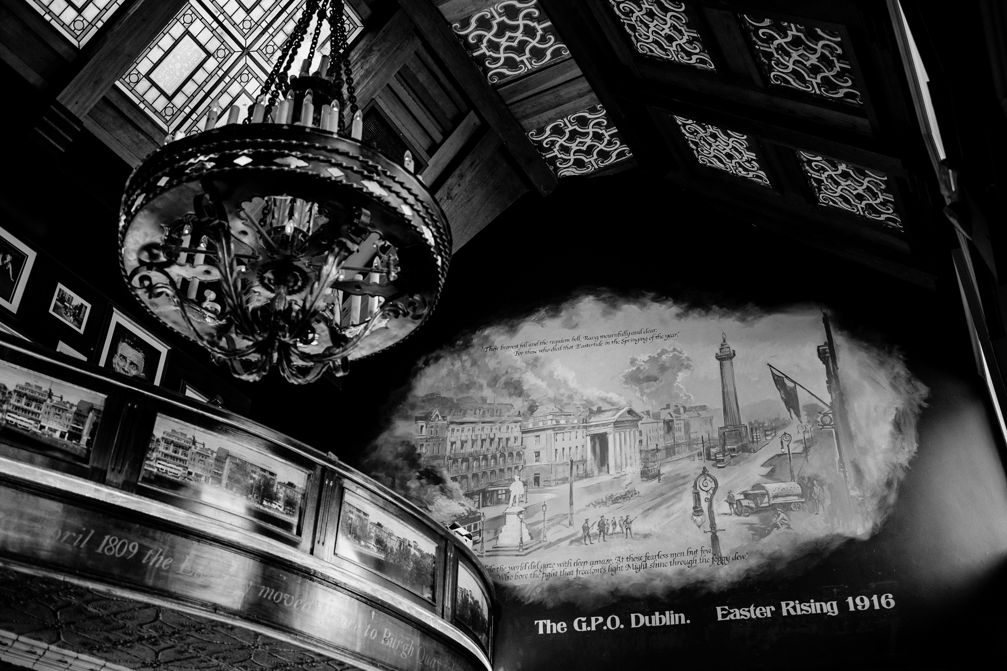 Black and white architectural photograph of an ornate ceiling and chandelier inside J.R. Mahon's pub in Dublin
