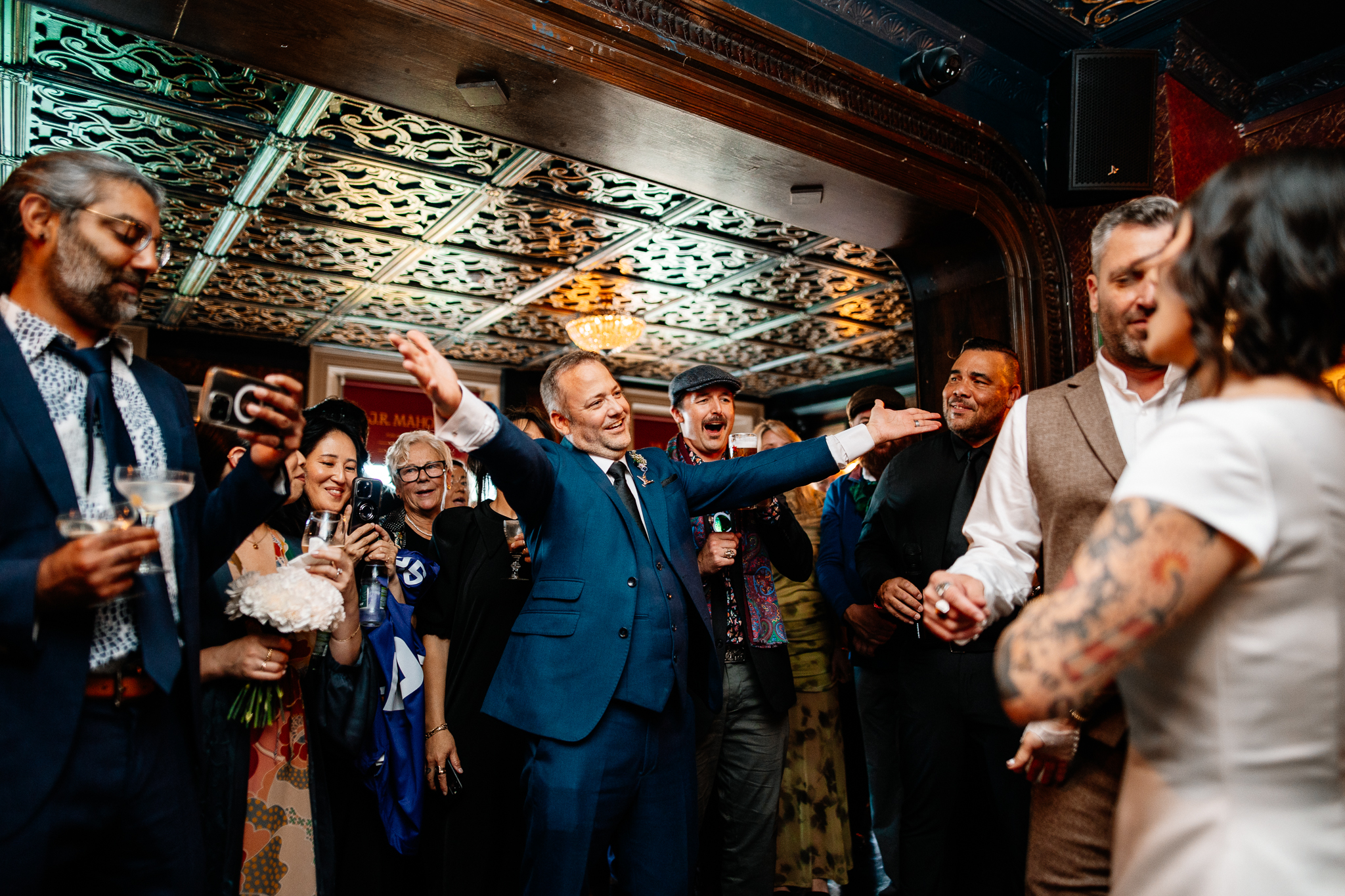 Wedding guests raising their hands during a lively reception at J.R. Mahon's in Dublin